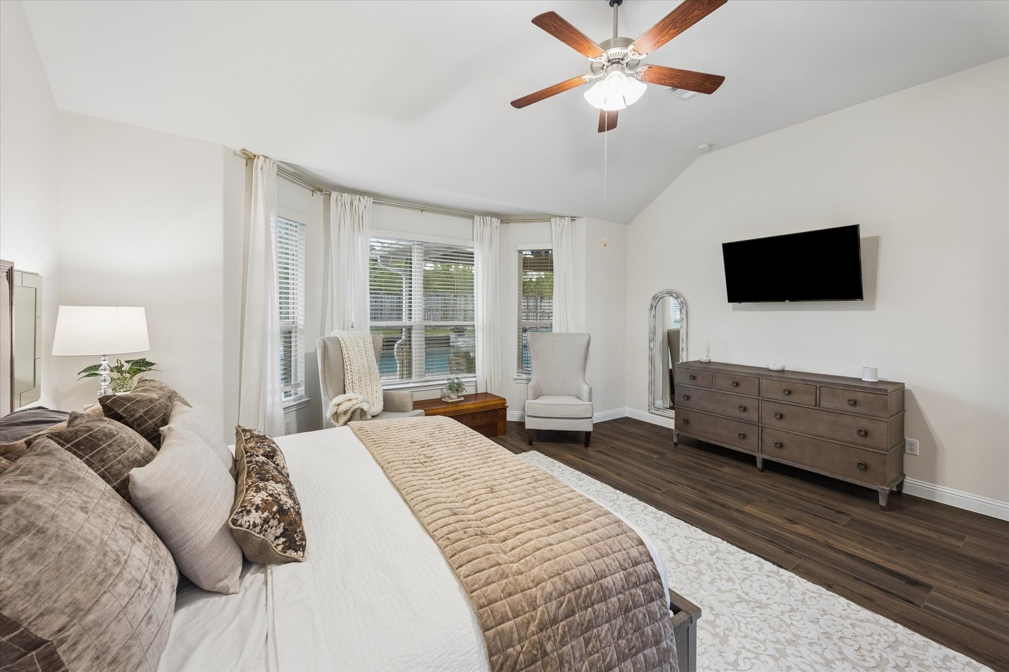 Beautiful bay of windows with stylish window treatment offers views of the backyard and pool area; the perfect spot to relax.