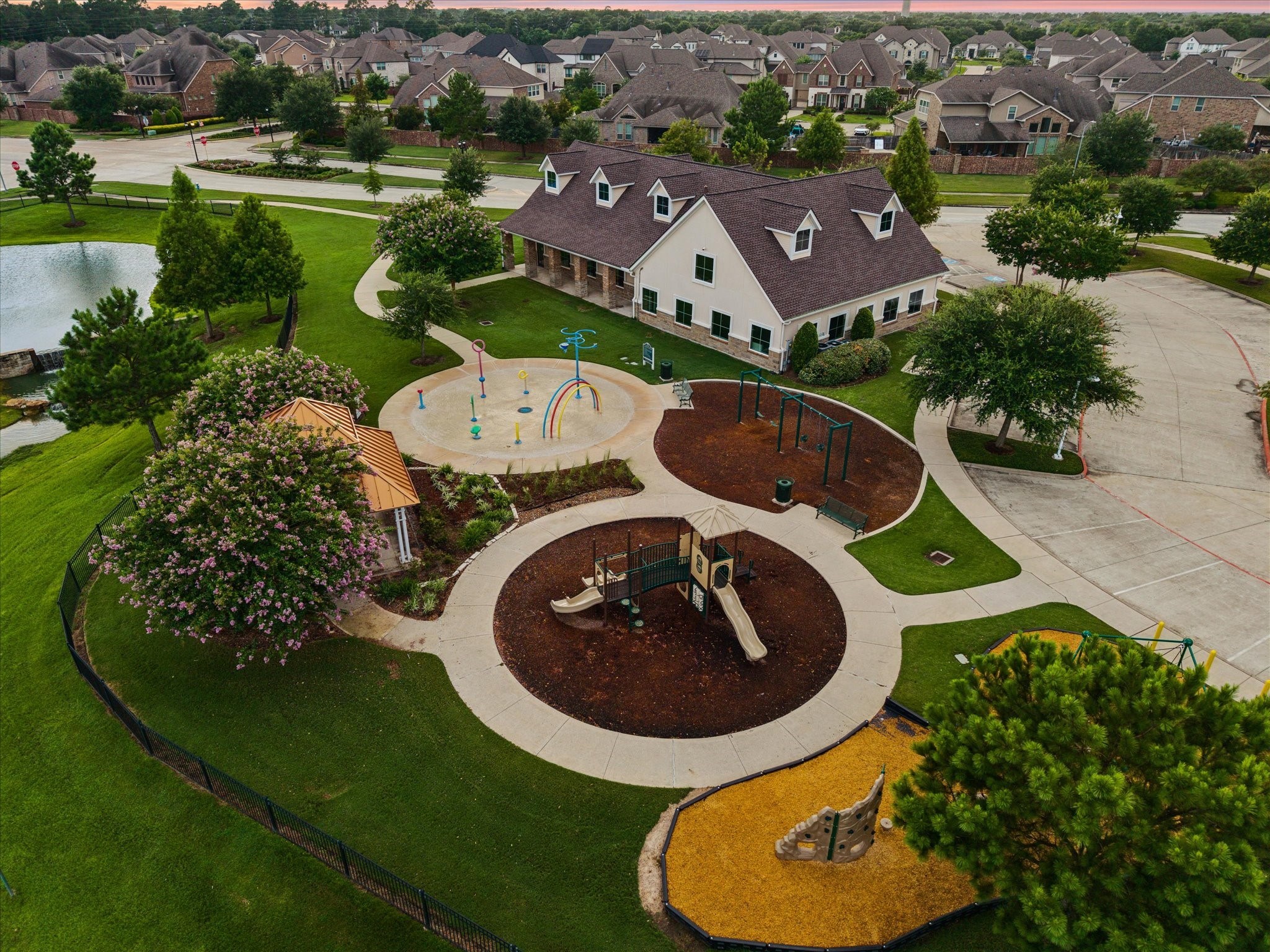 This aerial perspective showcases the communitys inviting layout, scenic ponds, winding streets, and expansive landscaped areas, creating a peaceful setting with a welcoming neighborhood feel.