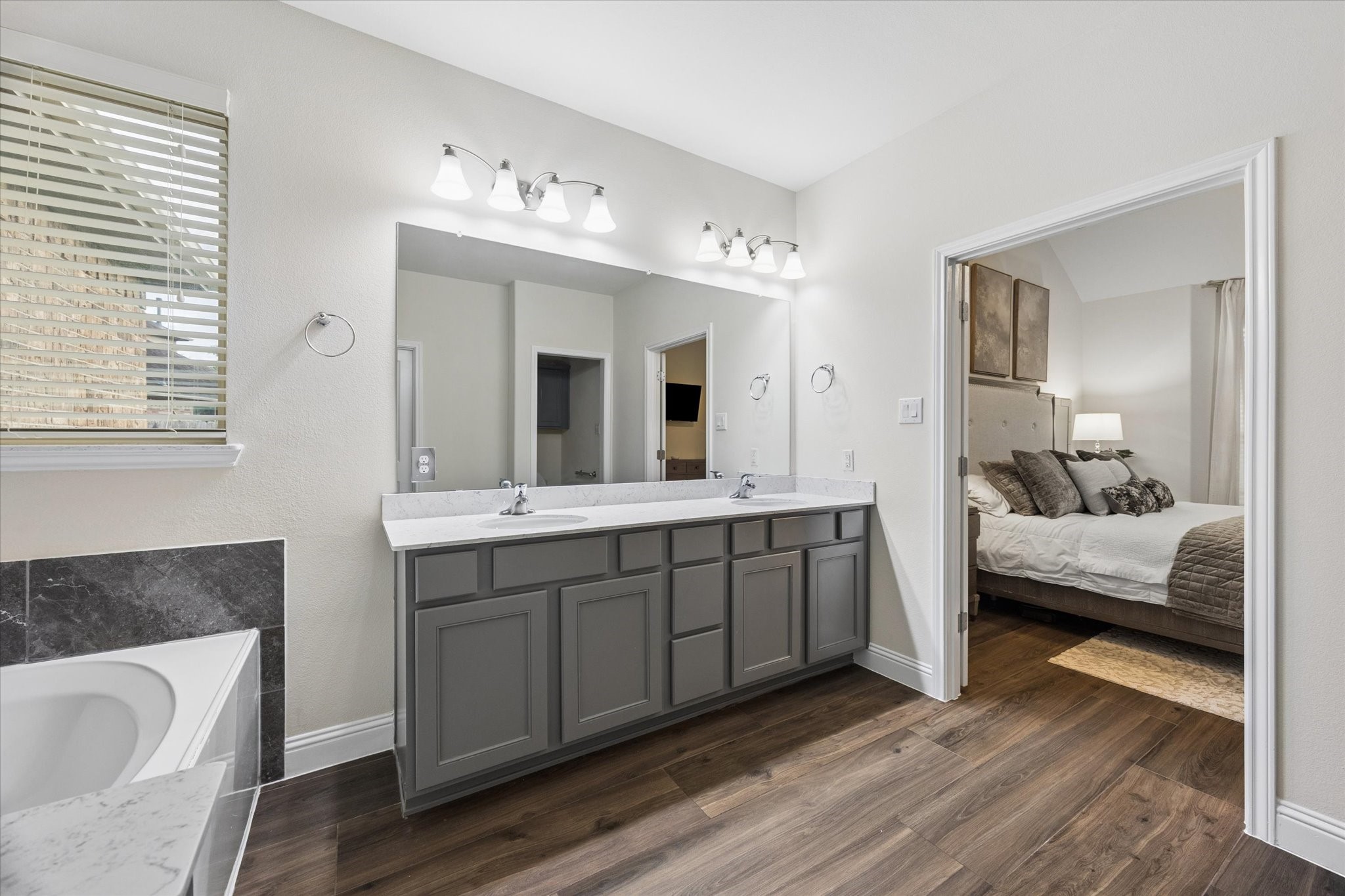 Stylish primary bathroom with plenty of cabinets for storage.