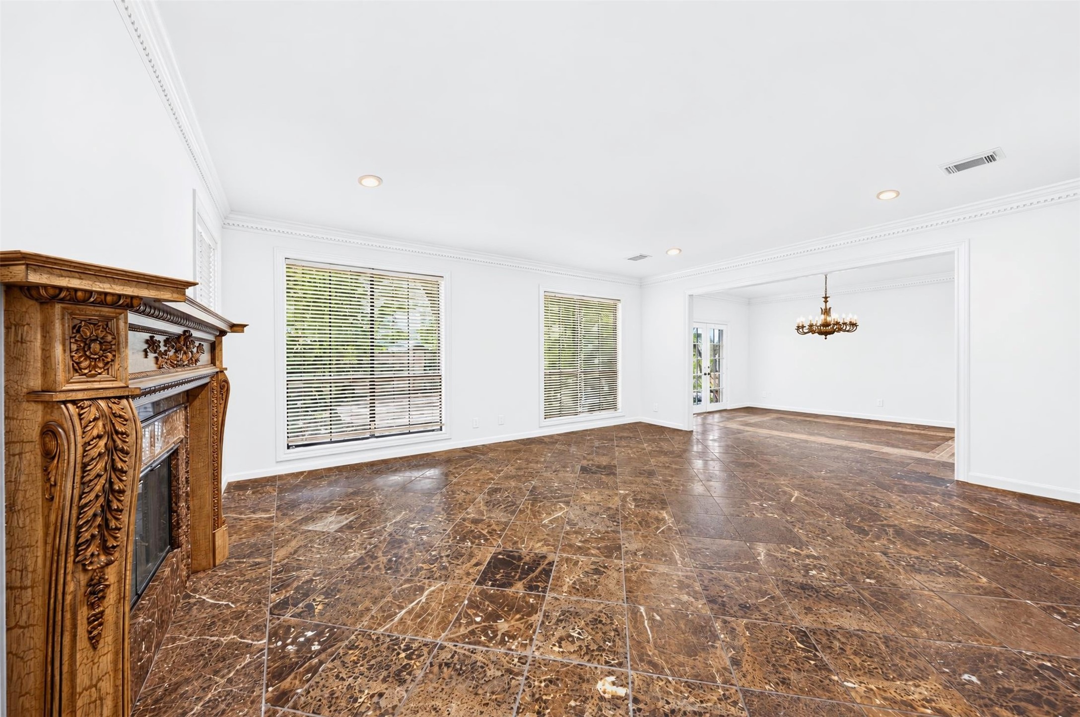 Living and dining areas connect through a wide opening beside courtyard-facing windows.