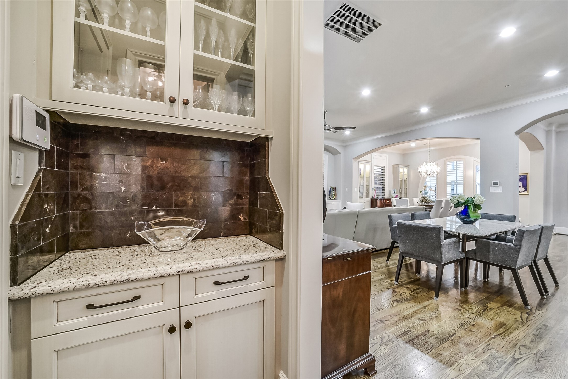 Elegantly appointed dry bar with ample storage makes a sophisticated addition for hosting guests.