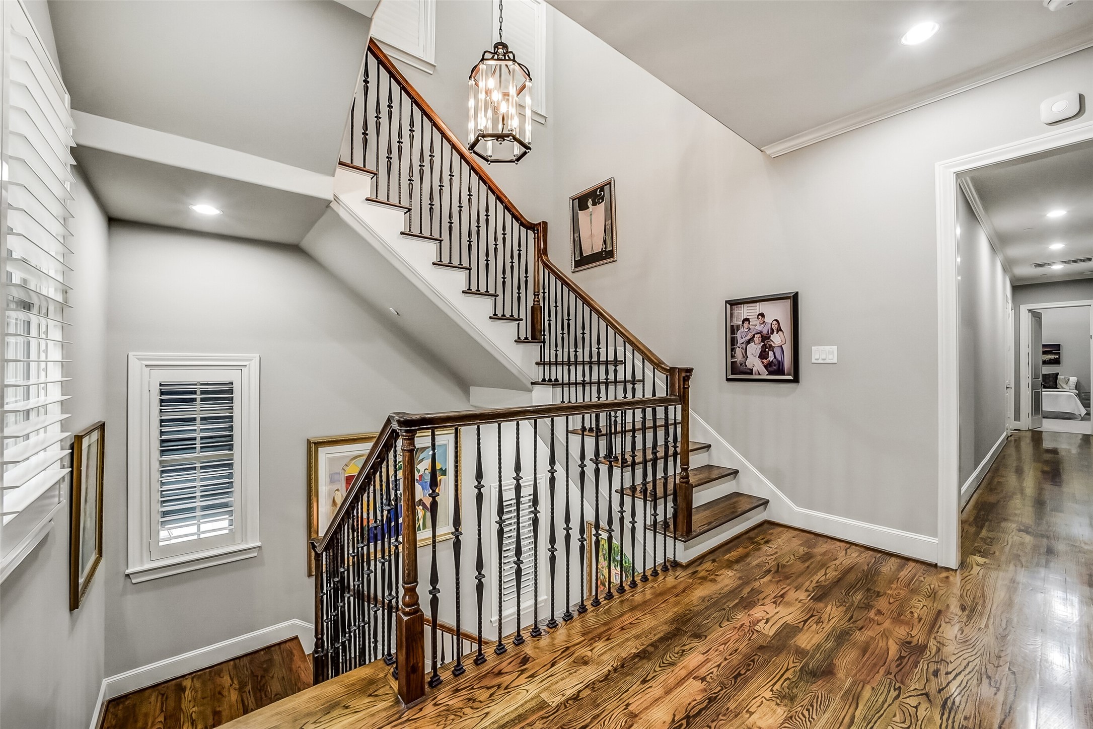 Second-floor landing with striking staircase providing seamless access up to the third floor and down to the main living level. On this floor is primary suite and two additional bedrooms.