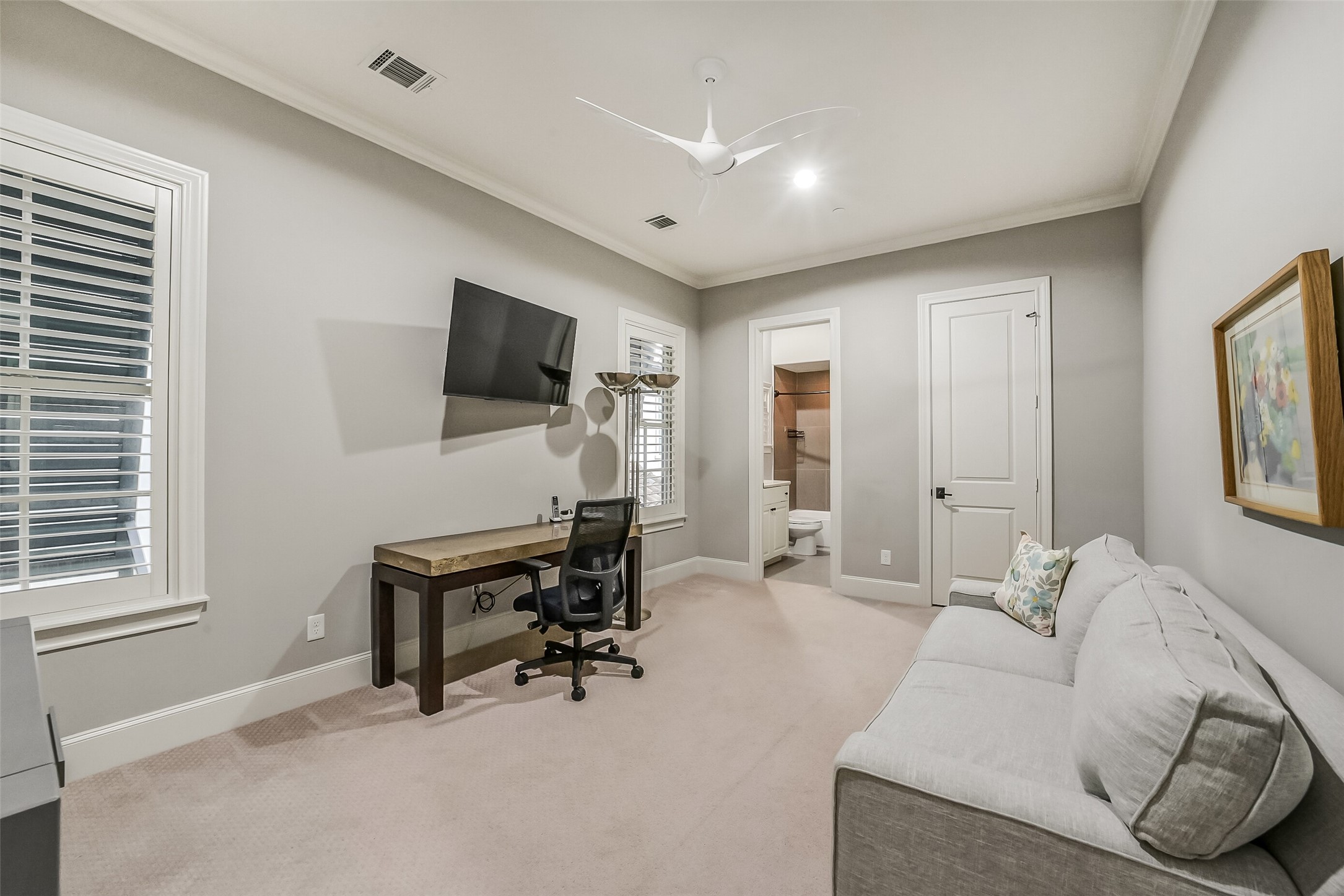 This spacious secondary bedroom is currently utilized as a flex space, showcasing the rooms versatility.