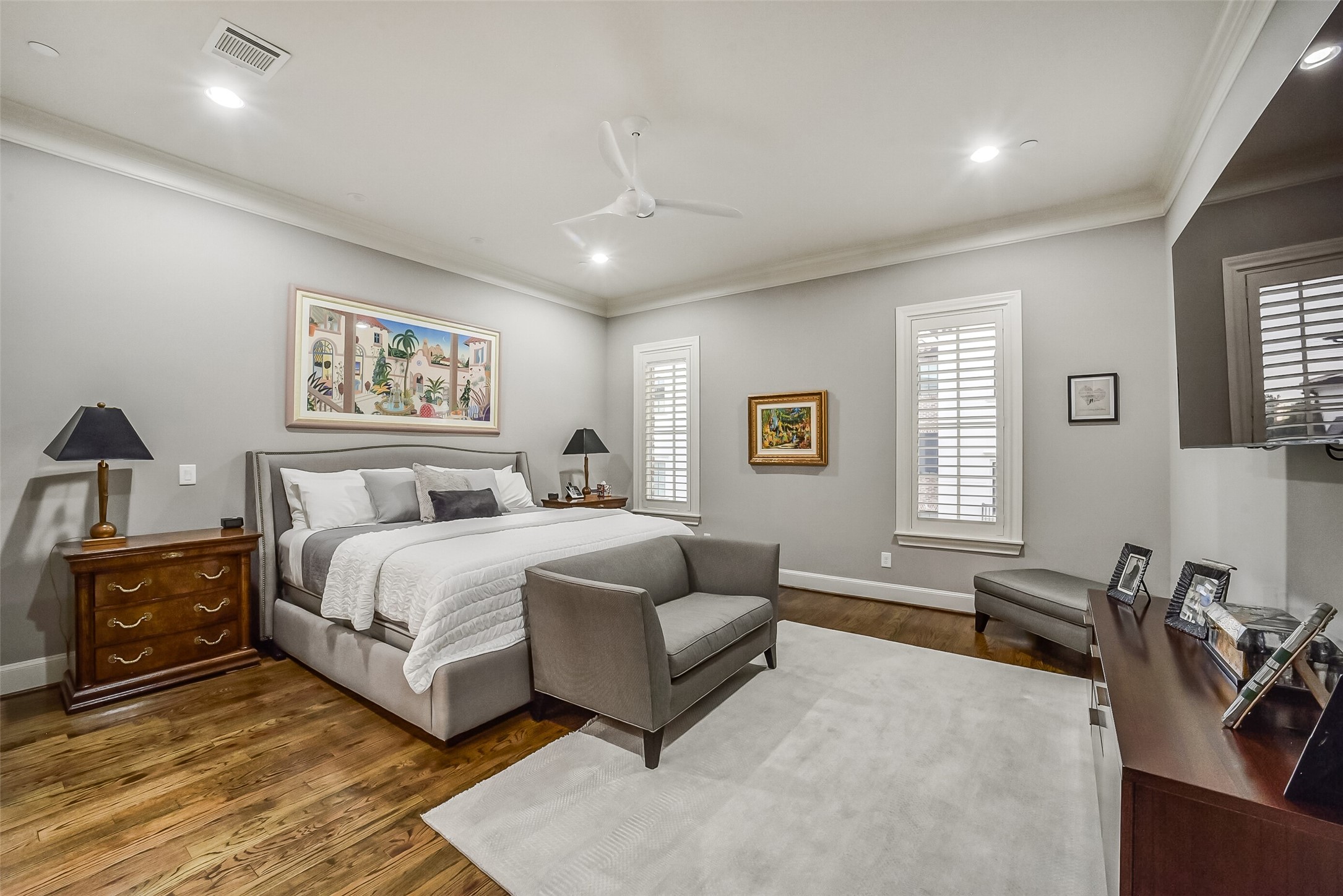 Private second-floor primary suite offers plenty natural lighting and provides ample space for a king sized bed and cozy seating area.