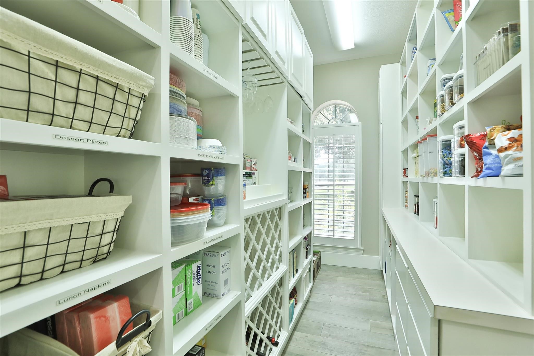 This impressive custom walk-in pantry is a dream come true, offering exceptional storage and organization with a touch of luxury!