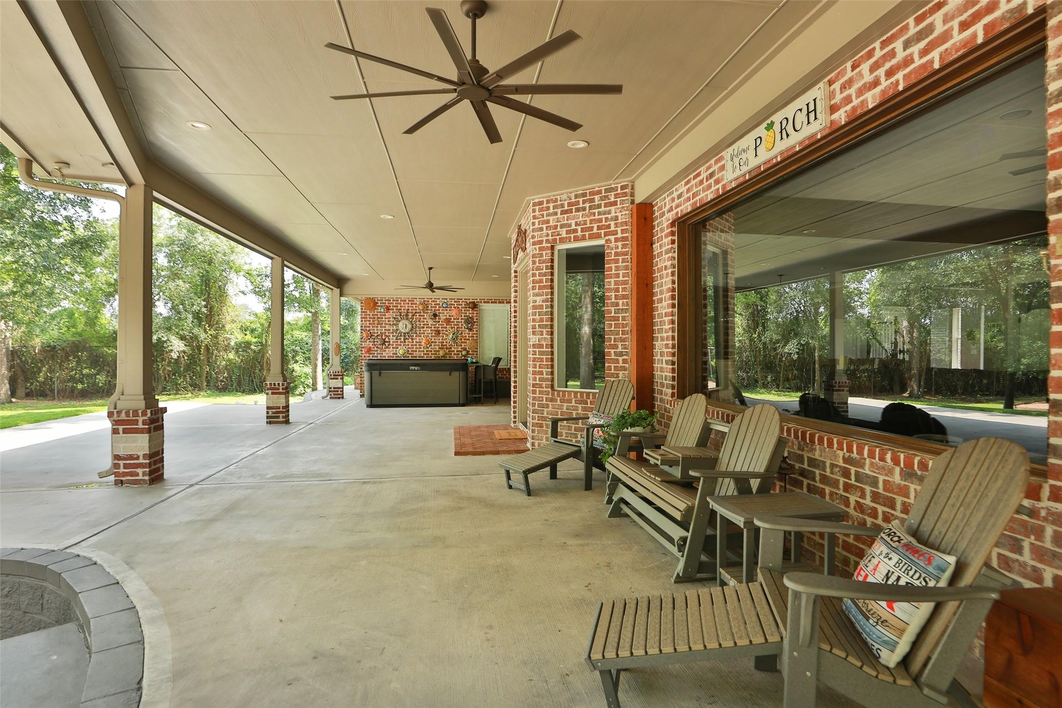 This expansive 64' x 32' covered patio is designed for year-round outdoor living and entertaining. Relax in the eight-person hot tub, unwind beneath the oversized ceiling fans, or enjoy peaceful mornings overlooking the beautifully landscaped backyard. The impressive covered space offers endless possibilities for outdoor dining, lounging, and hosting family and friends, all while being sheltered from the Texas sun.