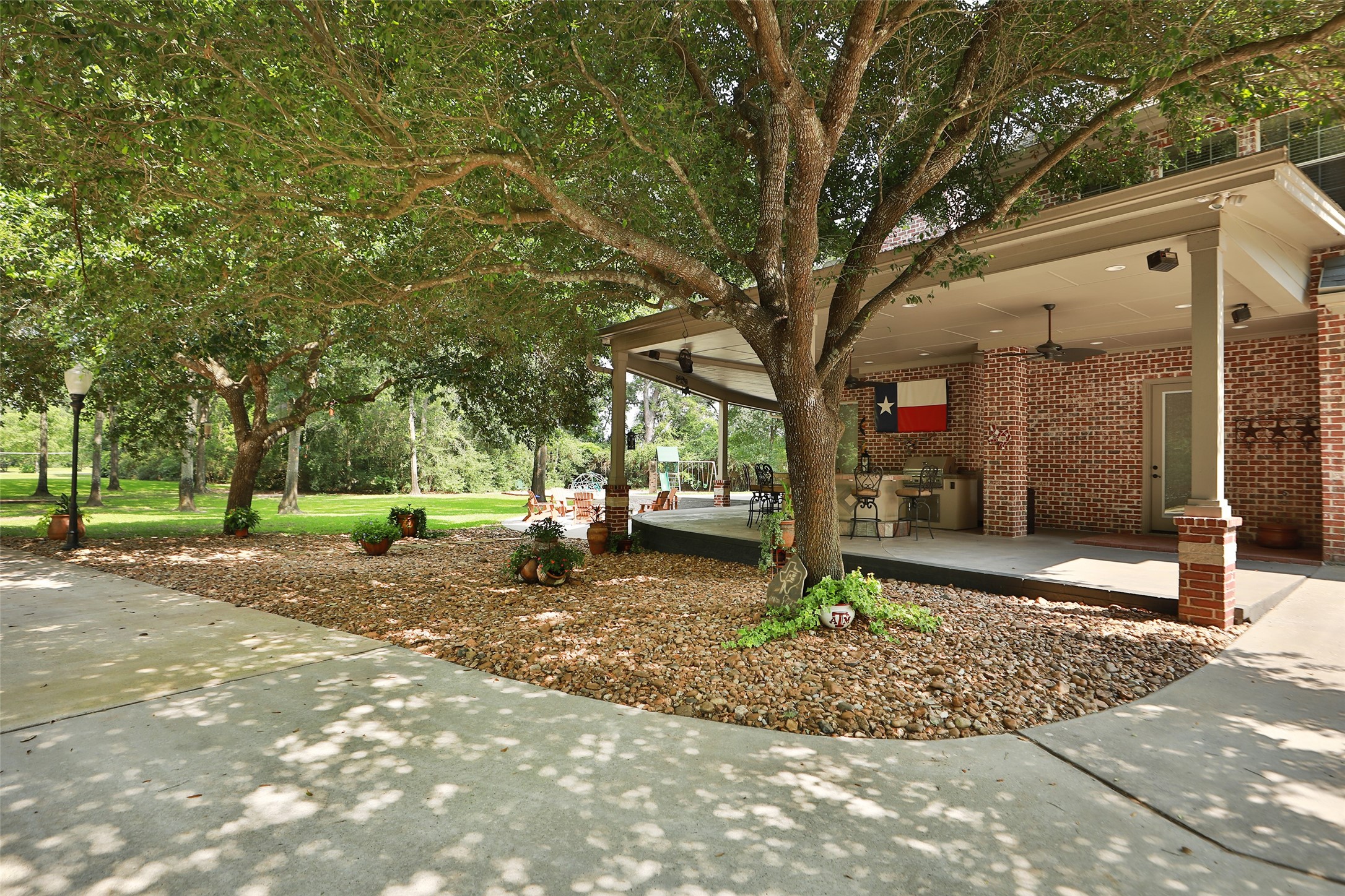 Outdoor entertaining at its finest! This incredible outdoor kitchen features a built-in grill, spacious bar seating, TV, beautiful lighting, and ceiling fans for year-round comfort. The perfect gathering place for family and friends to relax, dine, and make unforgettable memories!