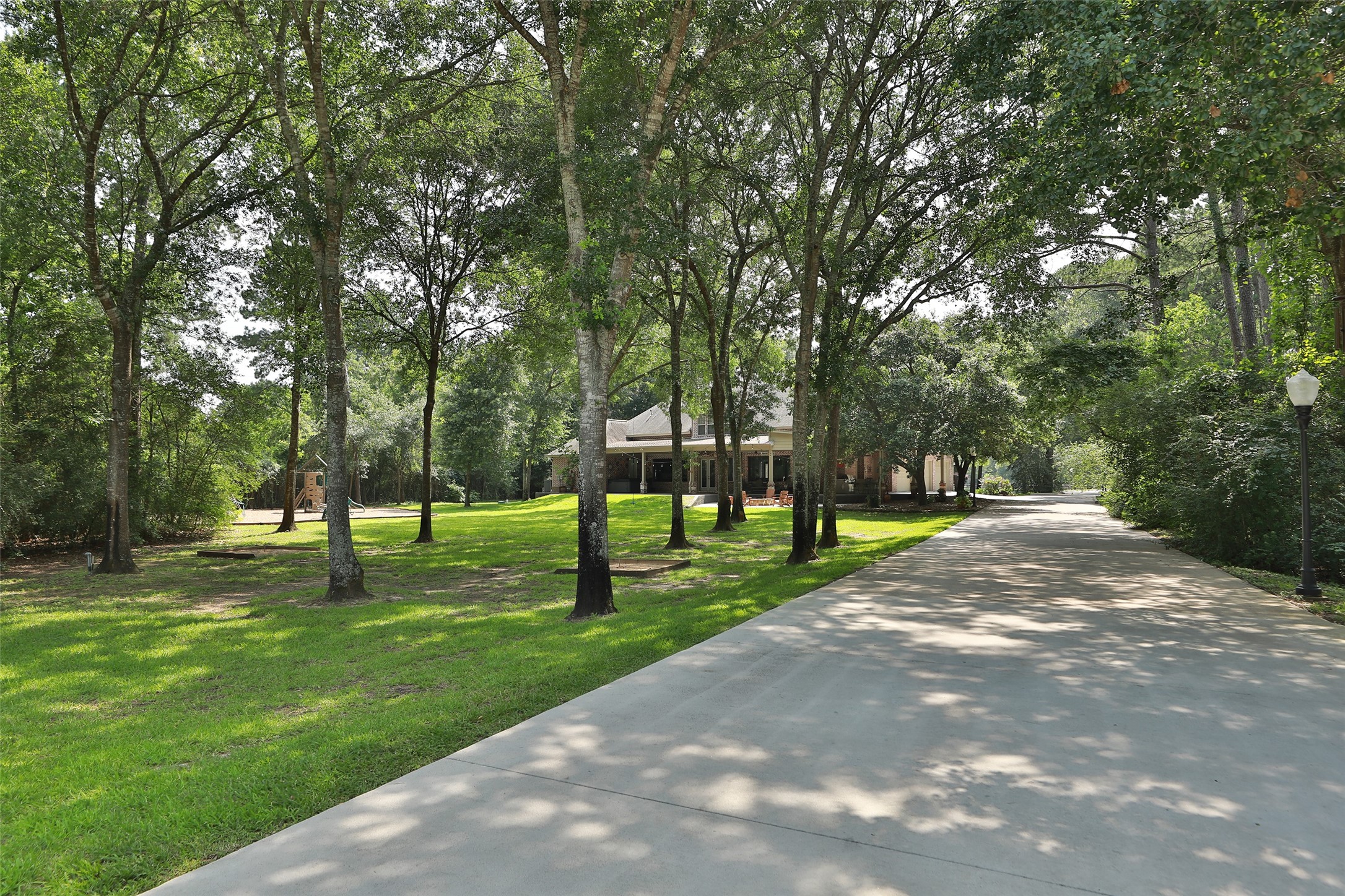 Escape to your own backyard oasis, surrounded by towering mature trees that provide shade, beauty, and exceptional privacy. The lush, manicured lawn offers plenty of space for recreation, while the horseshoe pits create the perfect gathering spot for a friendly competition and outdoor entertaining.