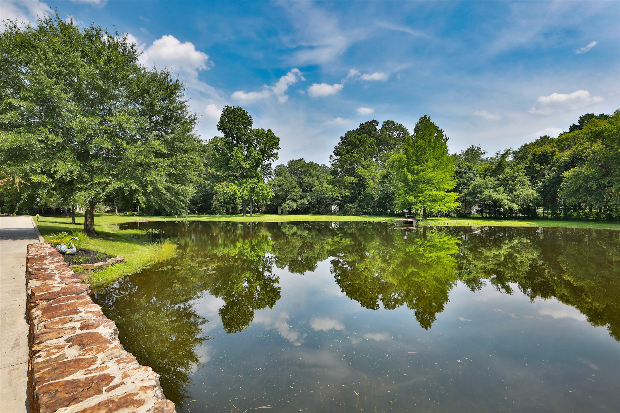 Imagine coming home every day to this breathtaking view! As you cross the charming stone bridge overlooking your private stocked pond, you're welcomed by the beauty and tranquility of your own estate. This isn't just a drivewayit's an unforgettable entrance to a place you'll love calling home! Imagine coming home every day to this breathtaking view! As you cross the charming stone bridge overlooking your private stocked pond, you're welcomed by the beauty and tranquility of your own estate. This isn't just a drivewayit's an unforgettable entrance to a place you'll love calling home!