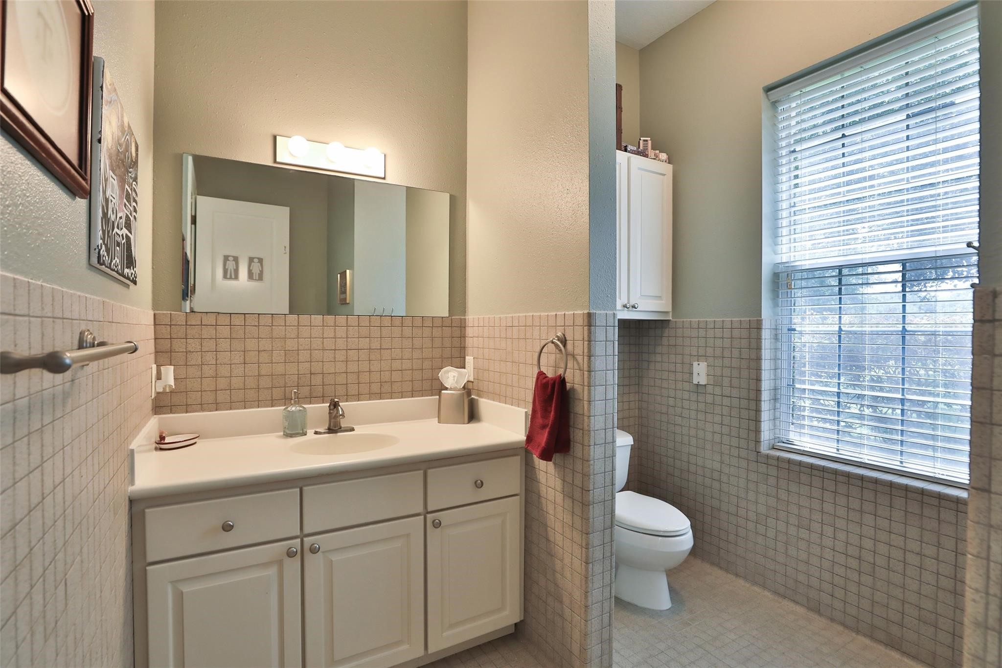 This garage bathroom is both practical and thoughtfully designed, making it a perfect addition to the ultimate workshop, showroom, or man cave.