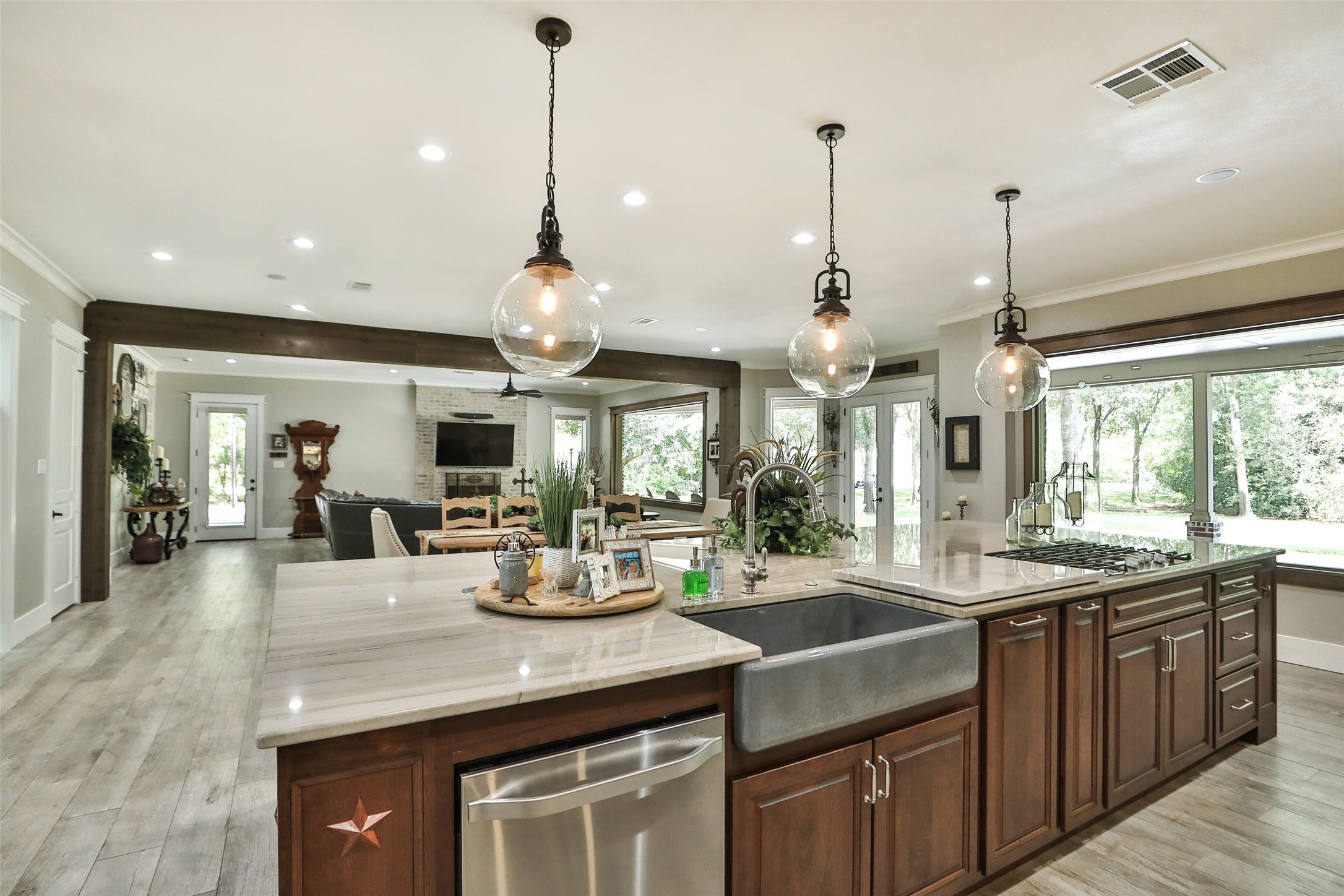 At the heart of this extraordinary estate is a magazine-worthy custom kitchen, beautifully remodeled with handcrafted floor-to-ceiling cabinetry, an impressive 15' x 7' solid cherry island, premium built-in LG Studio appliances, Taj Mahal quartzite countertops, designer lighting, and abundant storage. The open-concept design flows effortlessly into the dining and great room, creating an elegant yet welcoming space for entertaining on any scale. Combined with the home's extensive renovation.