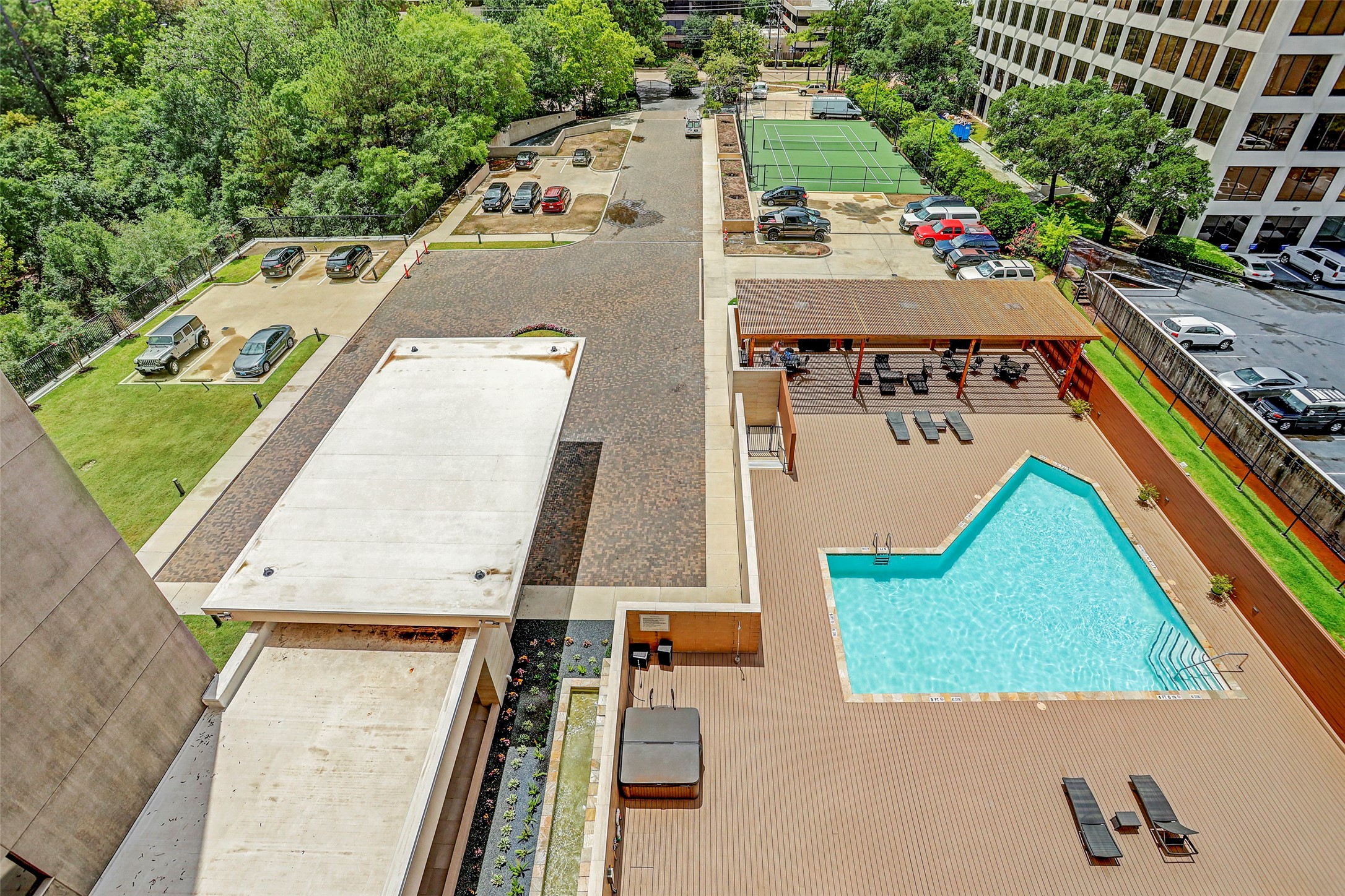 Aerial view of the pool, entry and tennis court.