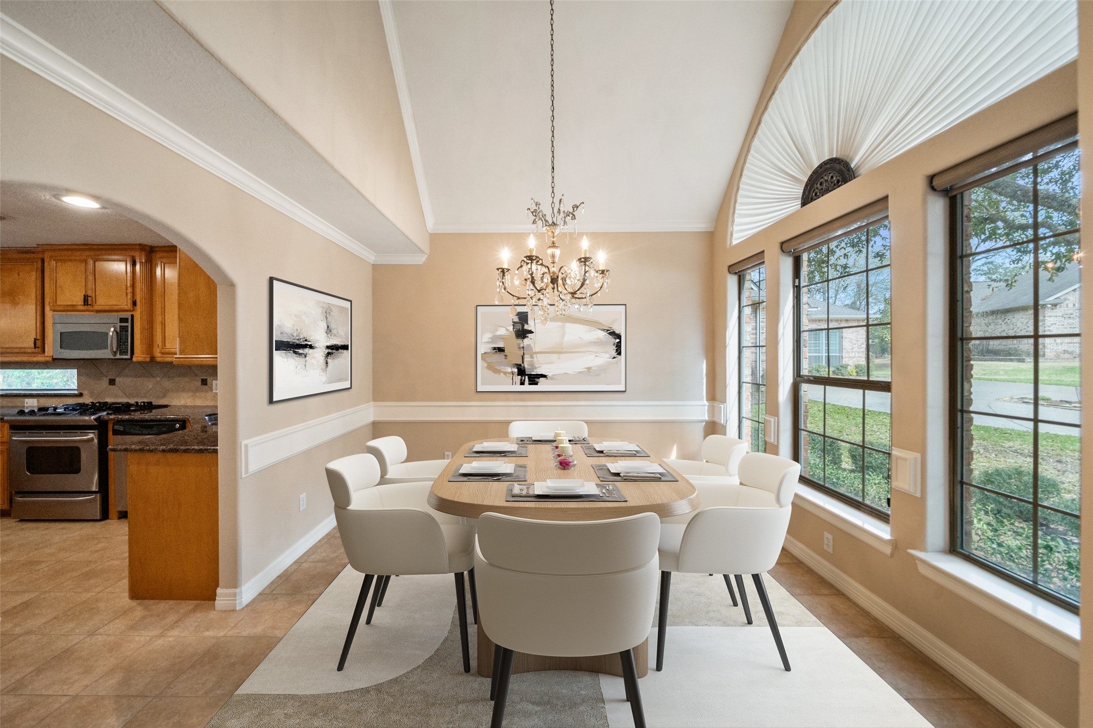 This inviting virtually staged dining area features large windows for ample natural light, a stylish chandelier, and elegant trim. It seamlessly connects to a modern kitchen creating a perfect setting for entertaining and family gatherings. This inviting virtually staged dining area features large windows for ample natural light, a stylish chandelier, and elegant trim. It seamlessly connects to a modern kitchen creating a perfect setting for entertaining and family gatherings.