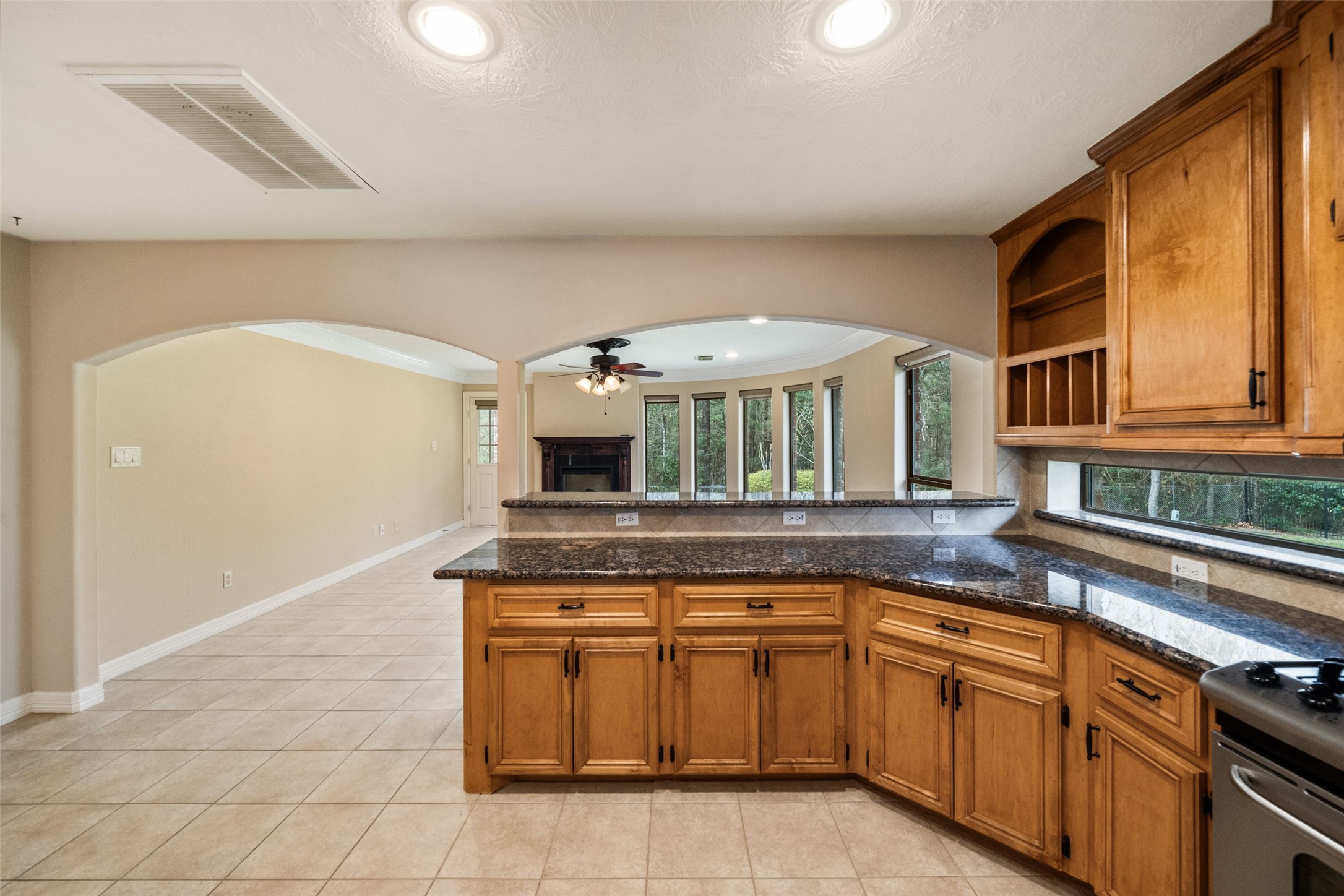Kitchen opens into a bright living area, The open floor plan enhances natural light and flow.