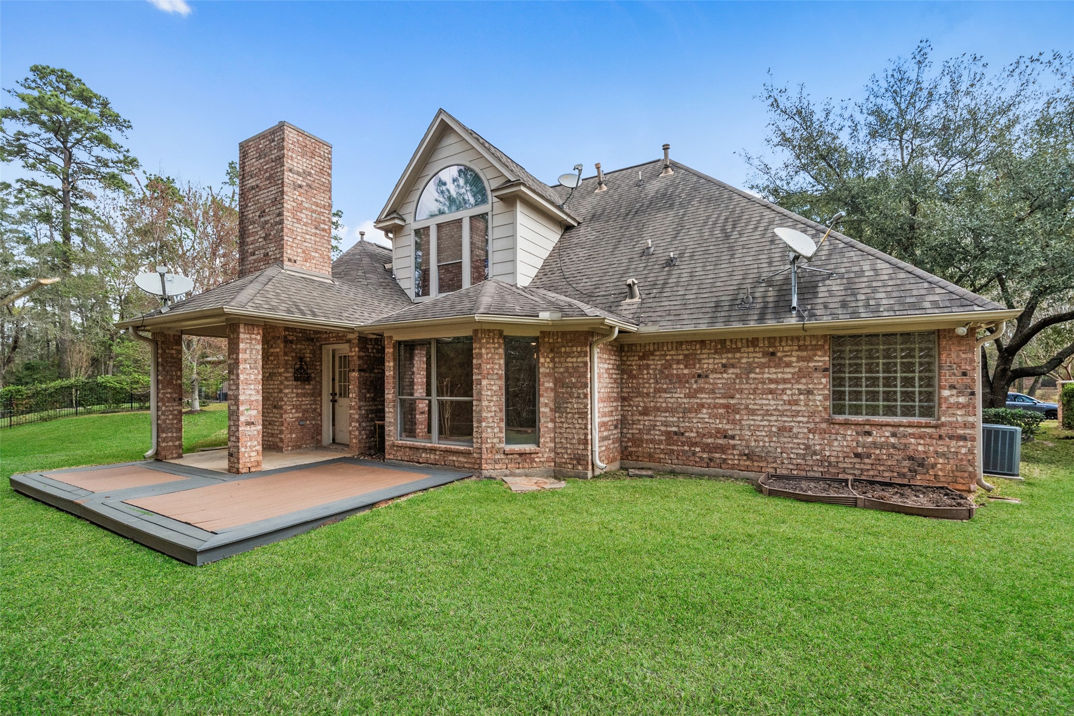 Spacious backyard and a large deck, perfect for outdoor entertaining. Surrounded by lush greenery for added privacy.