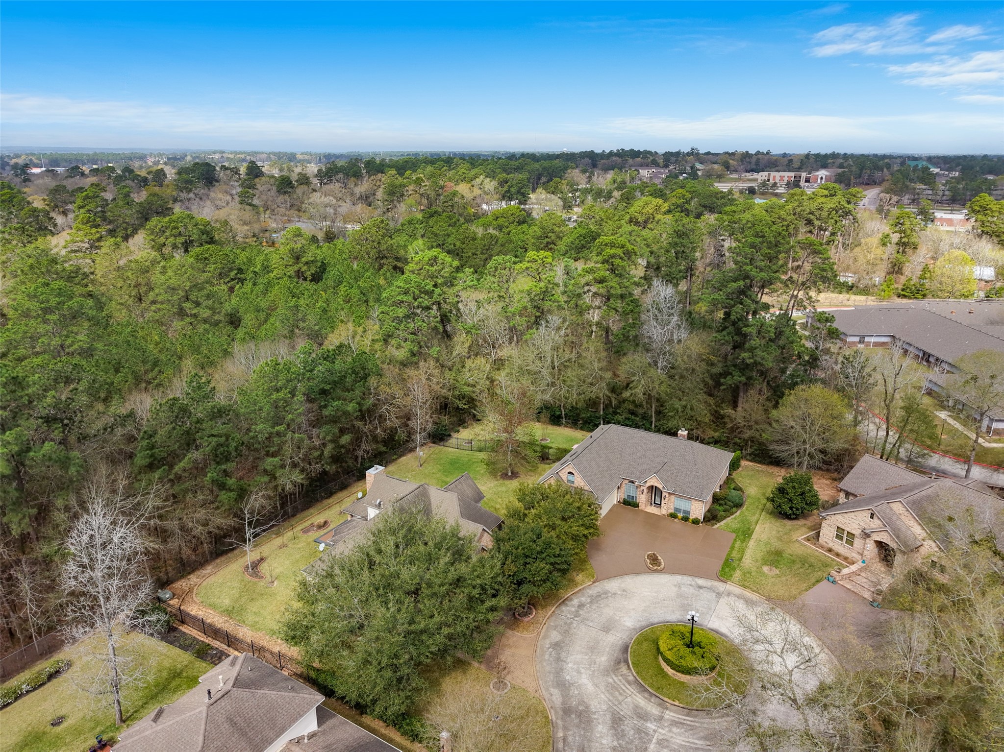 Home located in a serene gated neighborhood. The property is situated at the end of a quiet cul-de-sac, offering privacy and a picturesque setting with mature trees and well-maintained landscaping.