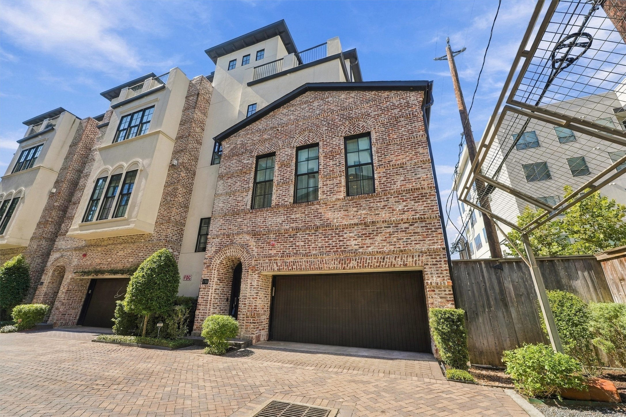 Brick-and-stucco faade with herringbone-set arches and black-framed windows, inside the gates of Castle Court Terrace