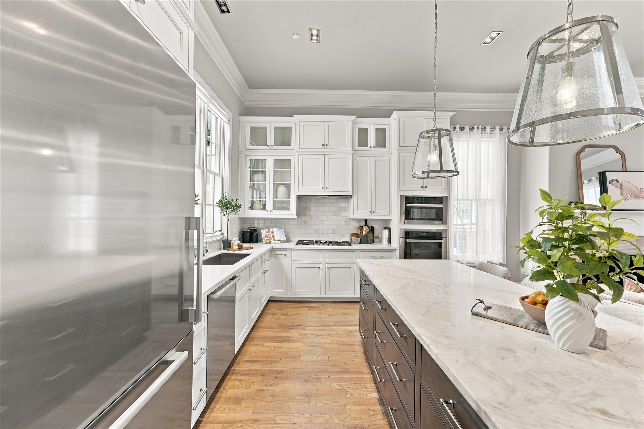Kitchen with a gas cooktop, subway-tile backsplash and Miele speed and convection ovens