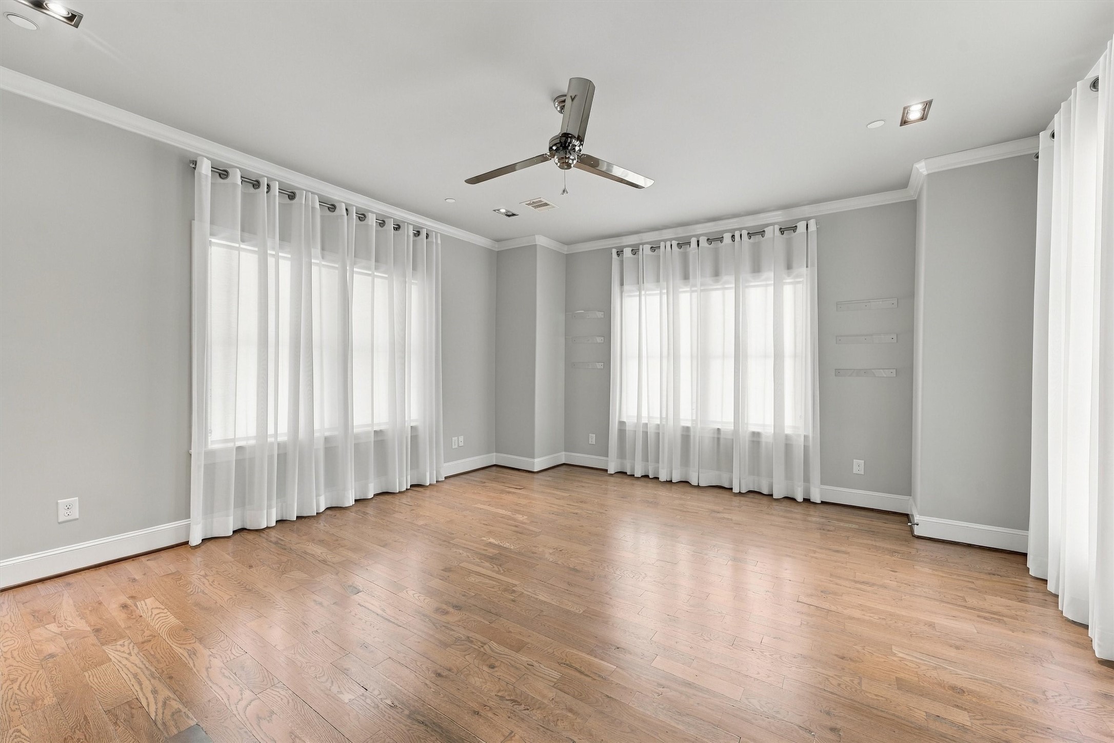 Fourth-floor bedroom with windows on three sides, its own bath and the terrace just outside
