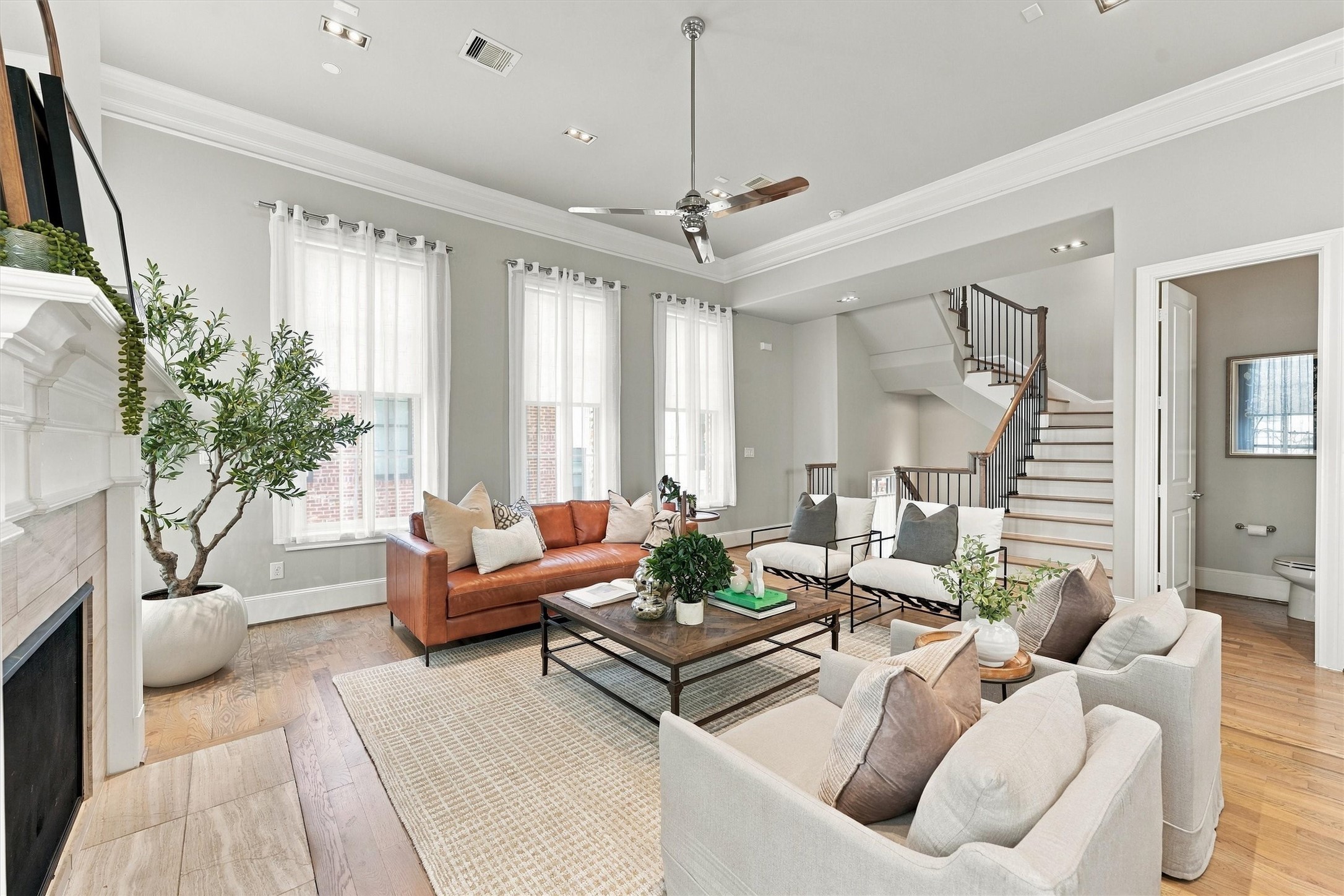 Great room open to the staircase, with a powder room just off the living area