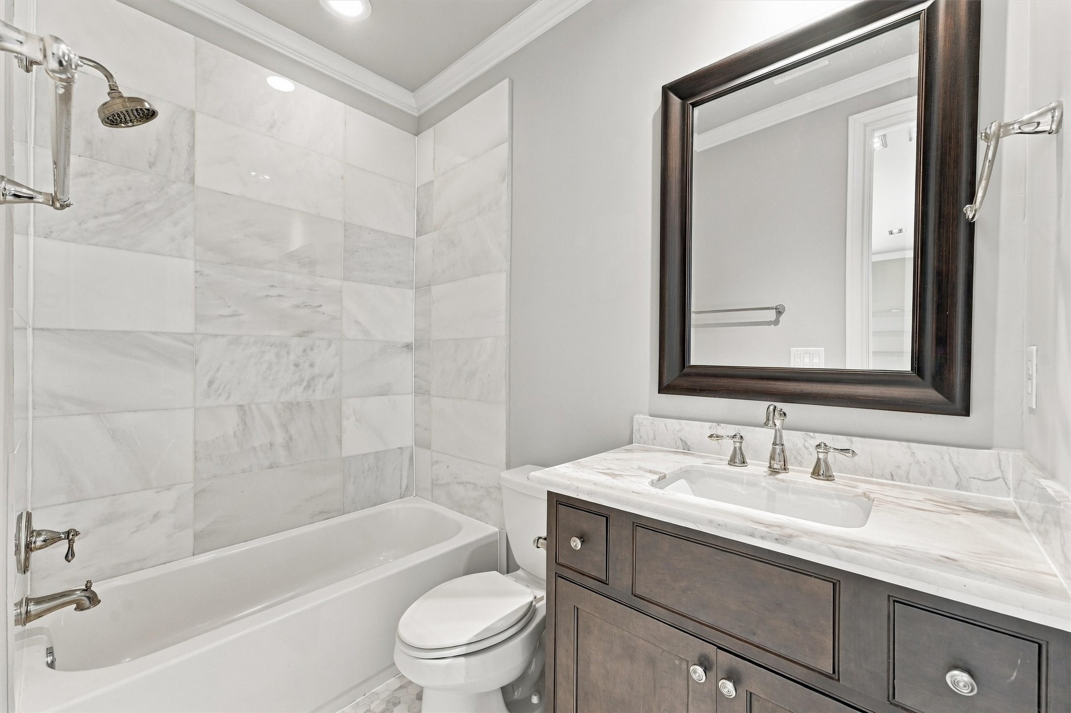 Fourth-floor bath with a marble-surround tub and shower