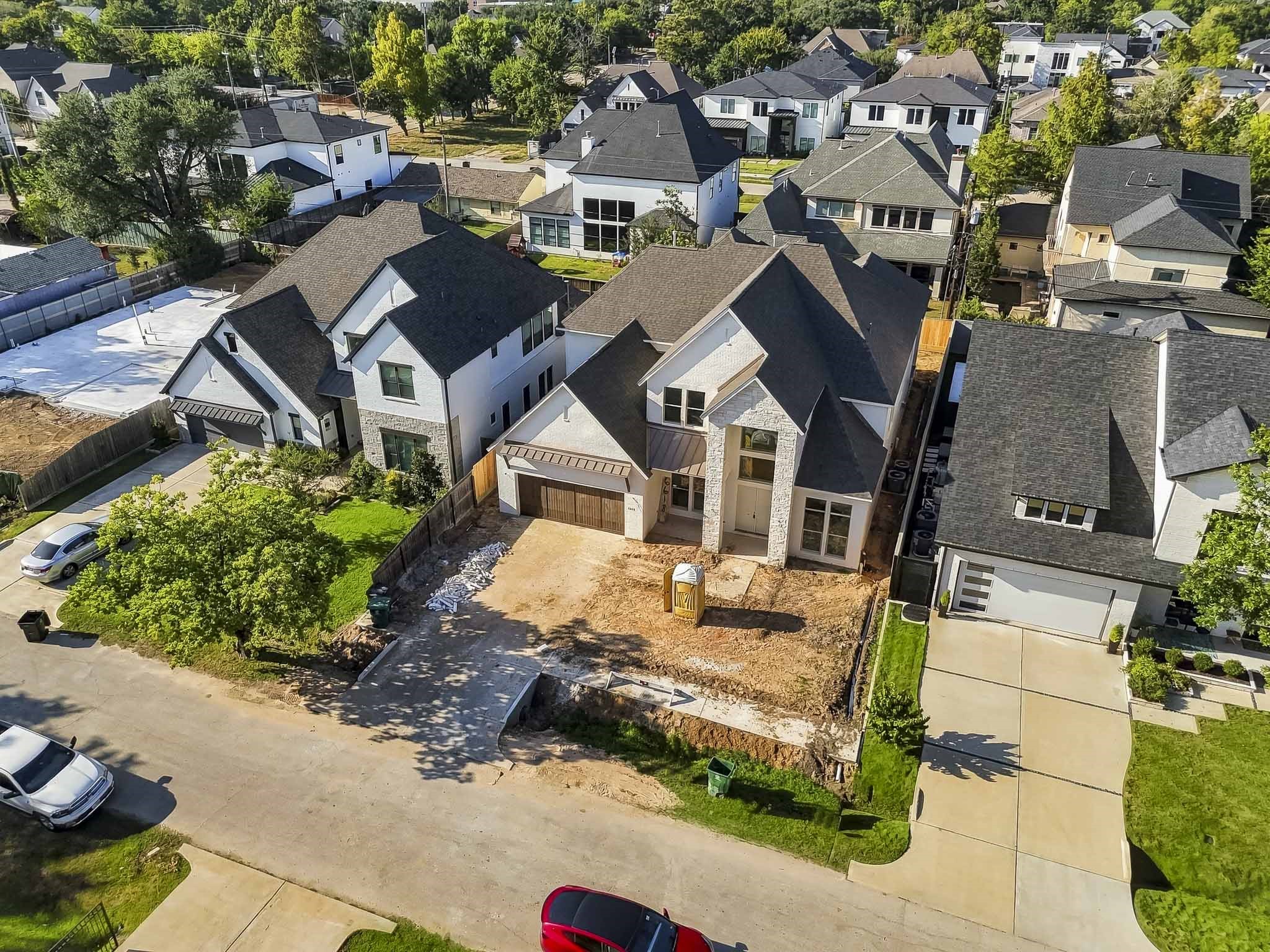 Stunning modern home in a desirable neighborhood, featuring a spacious driveway and elegant architectural design with large windows and a two-car garage!