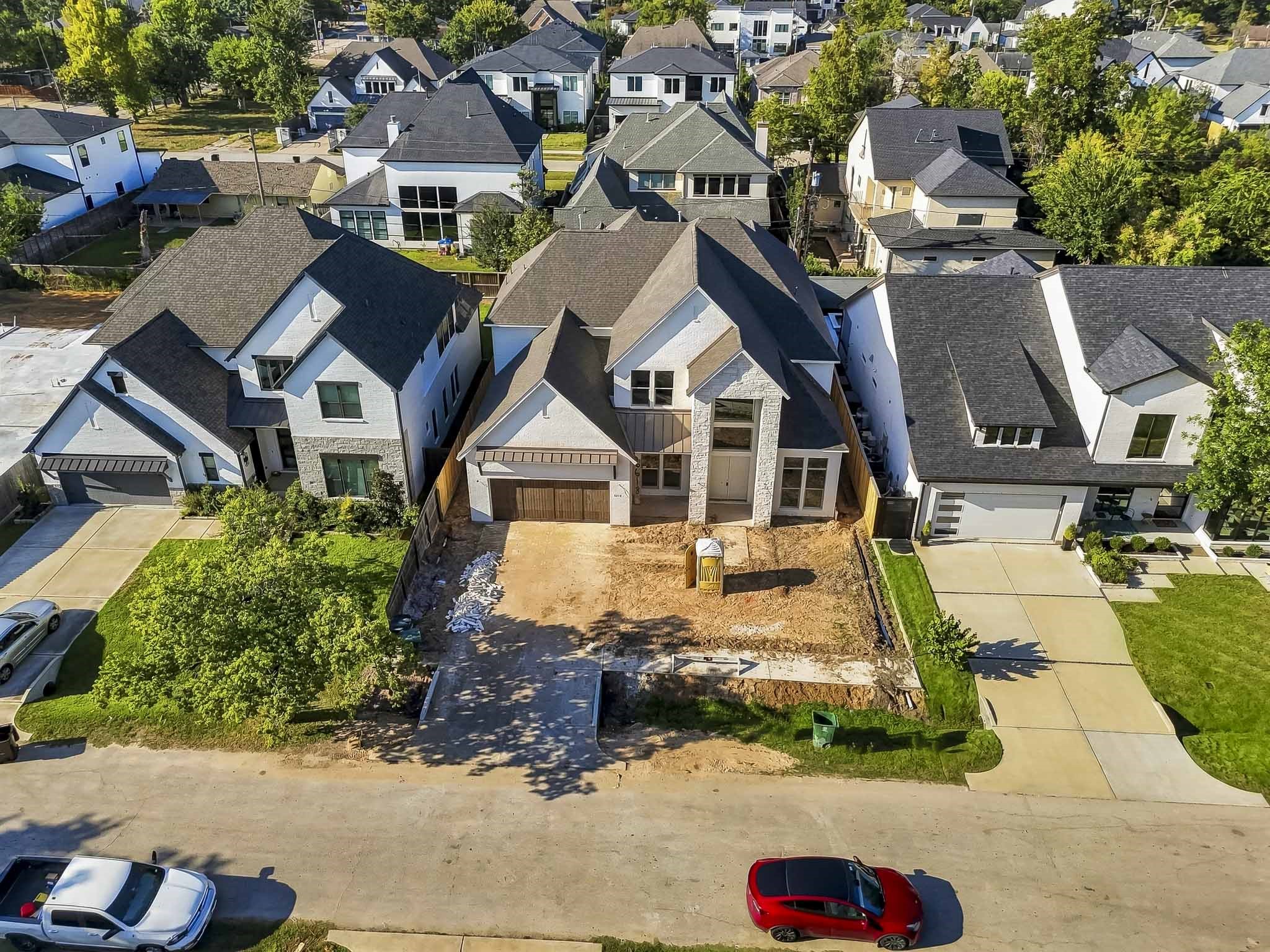 Modern two-story home featuring a spacious driveway and a striking facade with large windows. Situated in a well-developed neighborhood!