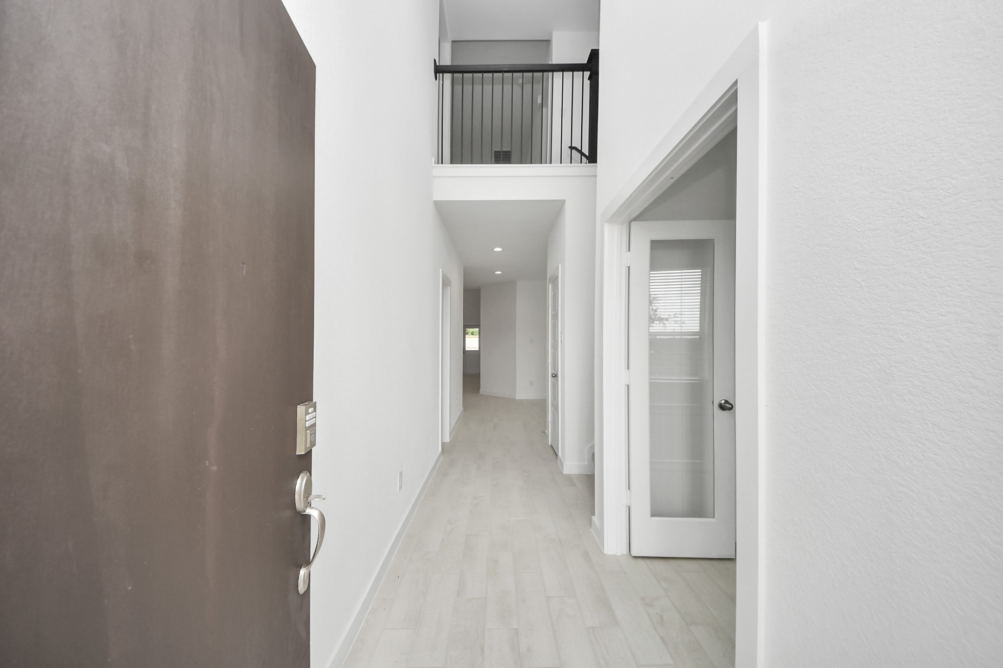 As you step into the threshold of this luxurious home, you'll soon be welcomed by an elegant glass door (to be installed). Inside, soaring ceilings amplify the spaciousness, while the refined wood-look tile flooring and oversized baseboards exude sophistication and charm. Sample photo of completed home with similar floor plan. Actual colors and selections may vary.