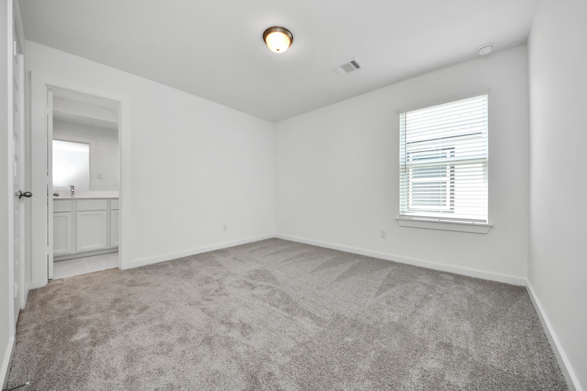 Generously sized secondary bedrooms featuring spacious closets, soft and inviting carpeting underfoot, large windows allowing plenty of natural light, and the added touch of privacy blinds for your personal retreat. Sample photo of completed home with similar floor plan. Actual colors and selections may vary.