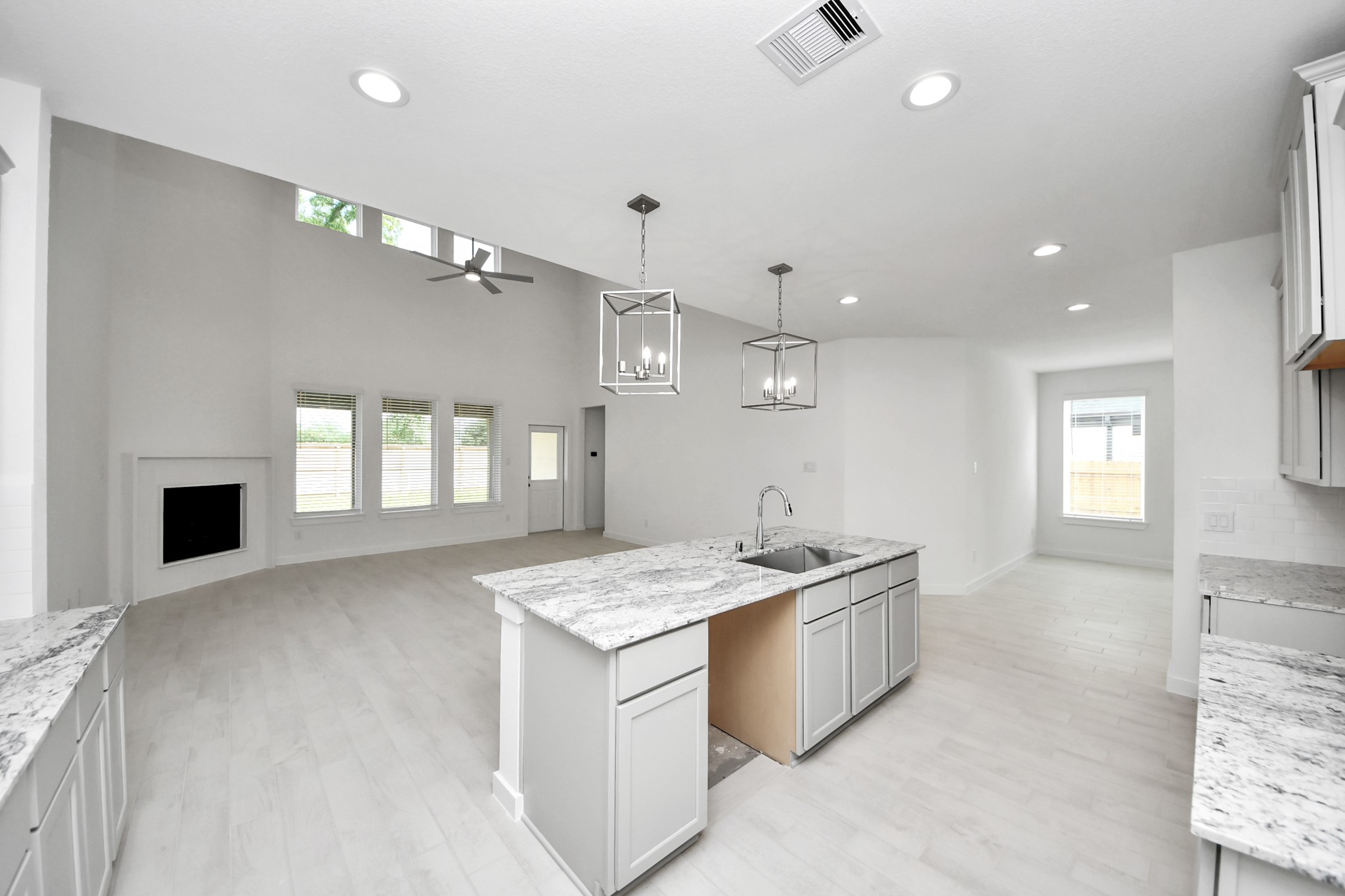 The open concept effortlessly connects the kitchen to the expansive family room, forming a perfect hub for gatherings. This seamless flow creates an inviting space where cooking and socializing come together harmoniously. Sample photo of completed home with similar floor plan. Actual colors and selections may vary.