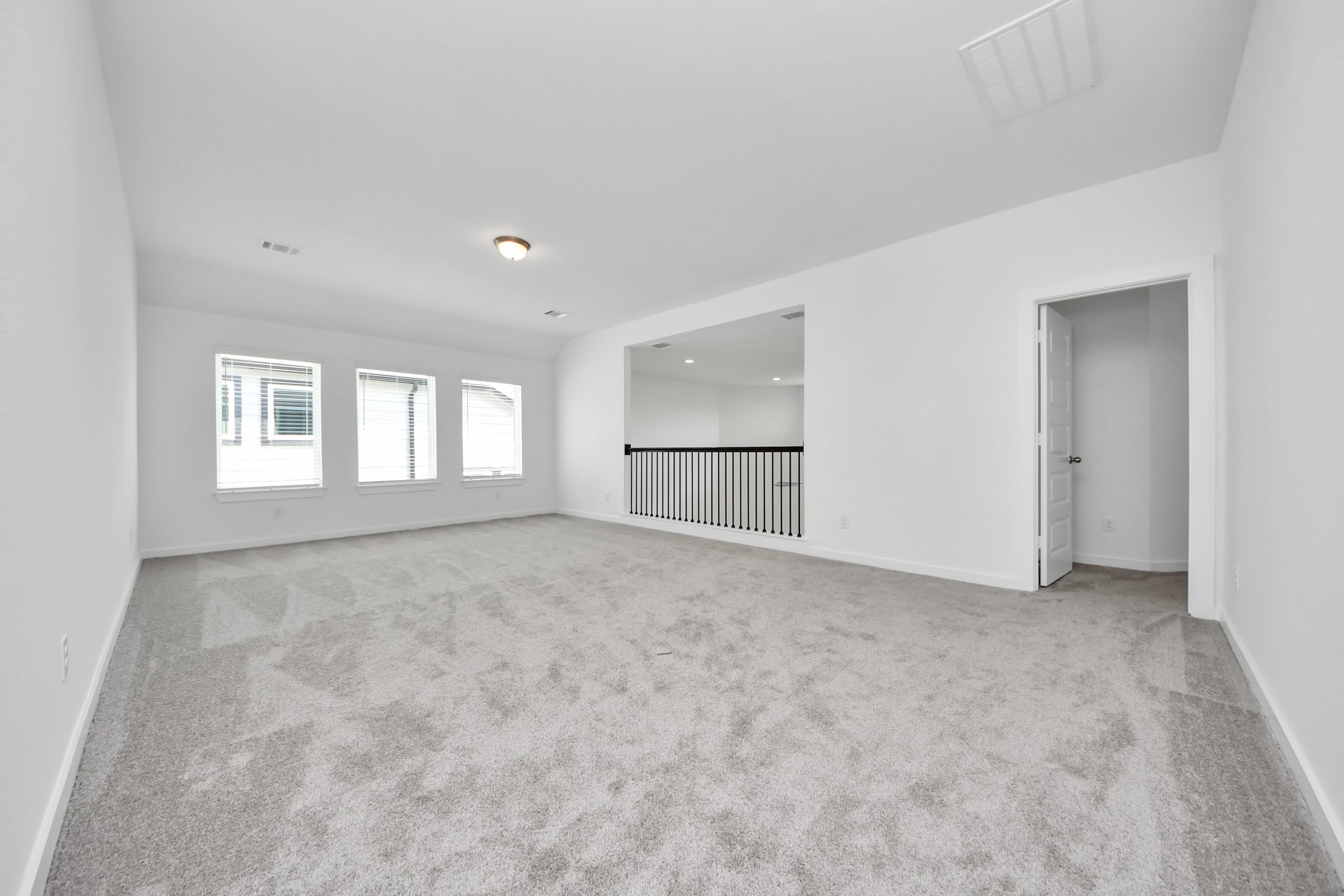 Come upstairs and enjoy a day of leisure in this fabulous game room! This is the perfect hangout spot or adult game room! Features plush carpet, high ceilings, custom paint and windows for plenty of natural light. Sample photo of completed home with similar floor plan. Actual colors and selections may vary. Sample photo of completed home with similar floor plan. Actual colors and selections may vary.
