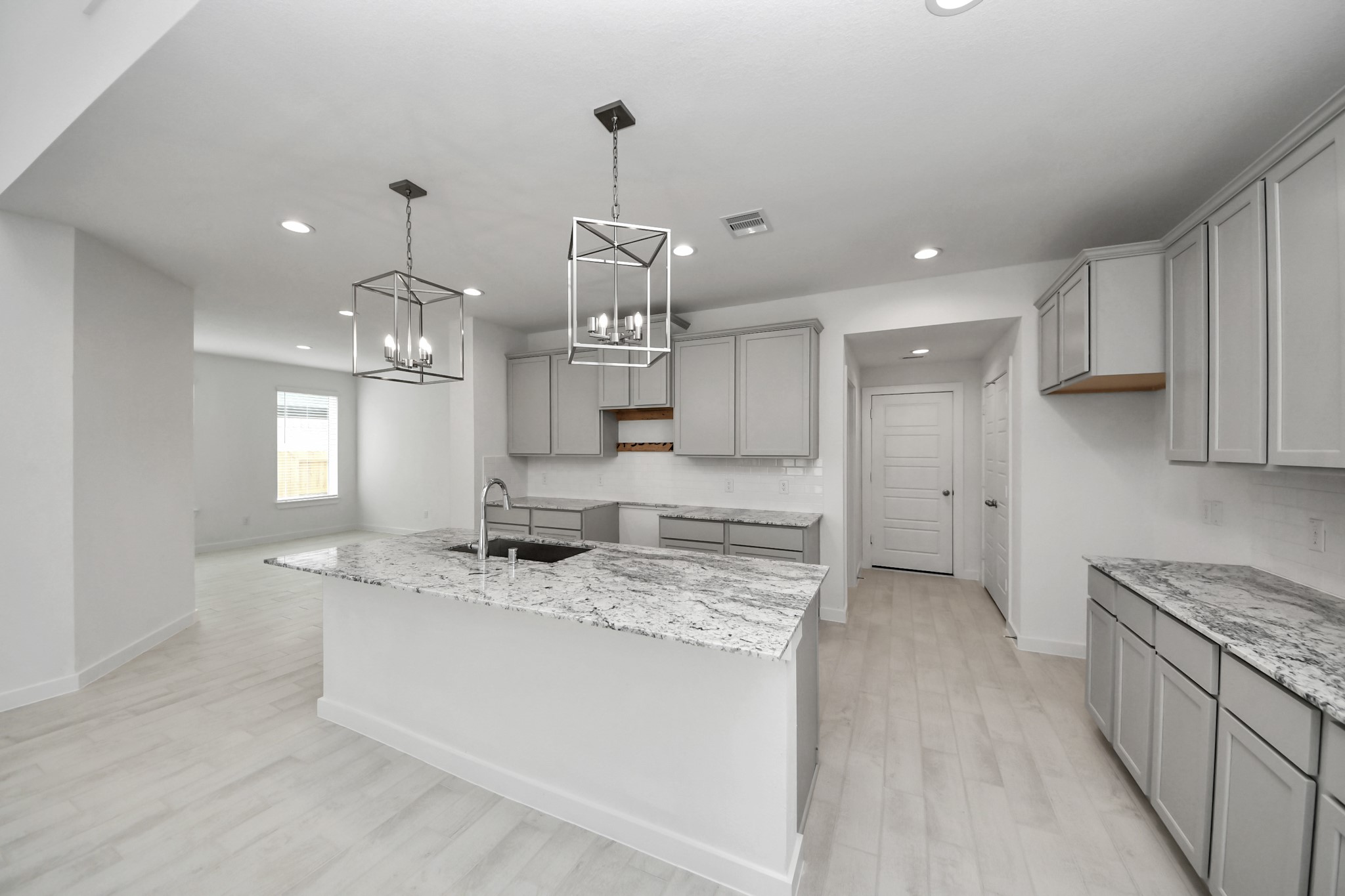 All of this overlooks your expansive family room, creating a perfect space for culinary delights and family gatherings. Sample photo of completed home with similar floor plan. Actual colors and selections may vary.