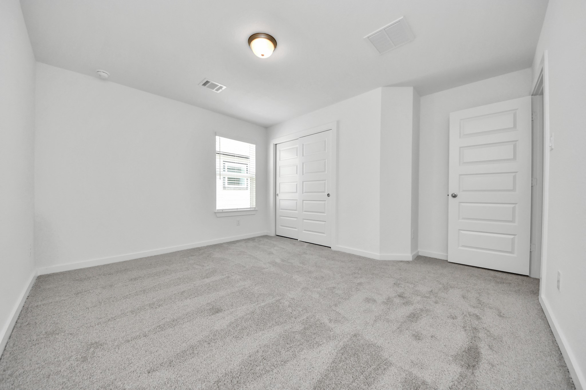 Generously sized secondary bedrooms featuring spacious closets, soft and inviting carpeting underfoot, large windows allowing plenty of natural light, and the added touch of privacy blinds for your personal retreat. Sample photo of completed home with similar floor plan. Actual colors and selections may vary.