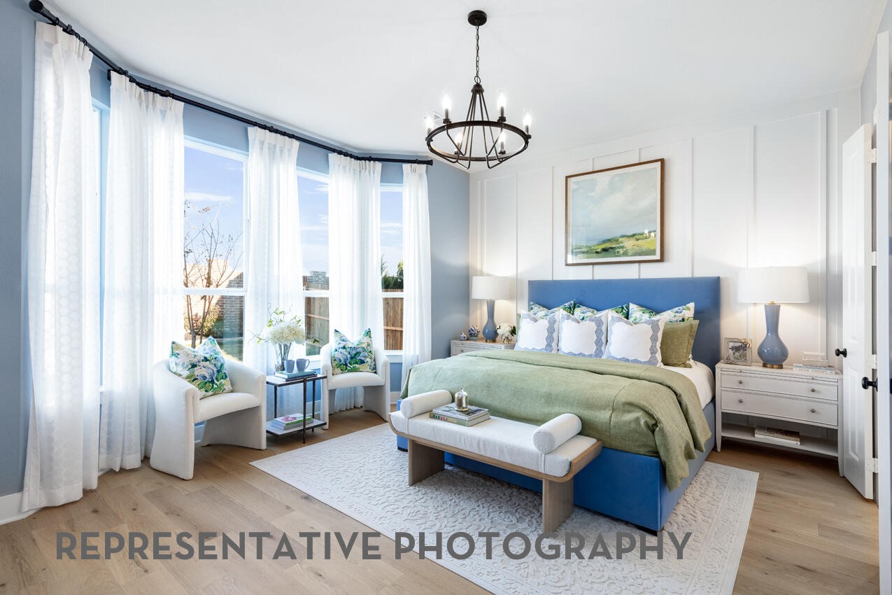 Spacious primary suite with oversized windows, abundant natural light, and room to unwind.