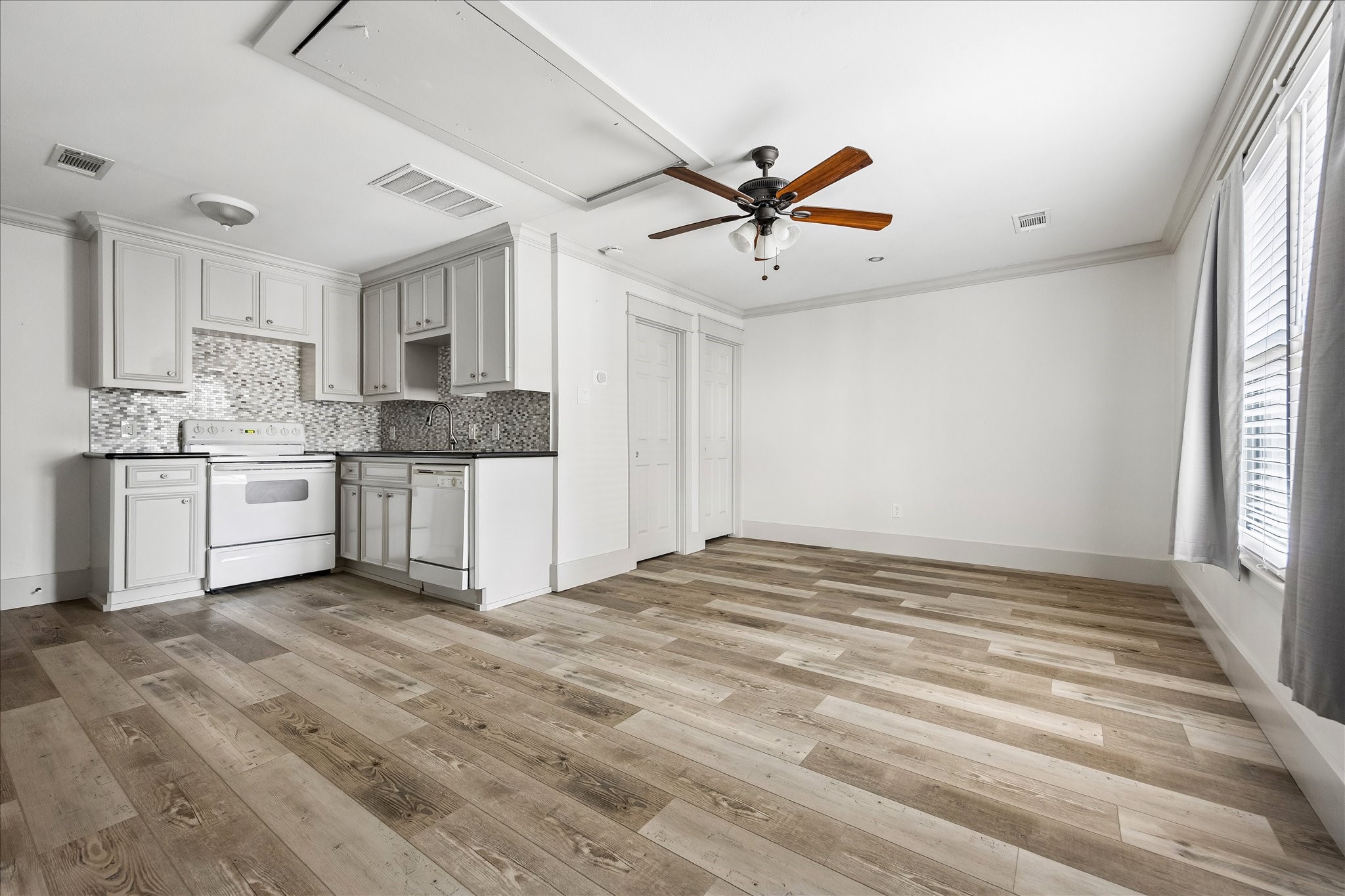 A finished apartment above the garage offers flexible additional living space, complete with a kitchenette and abundant natural light.
