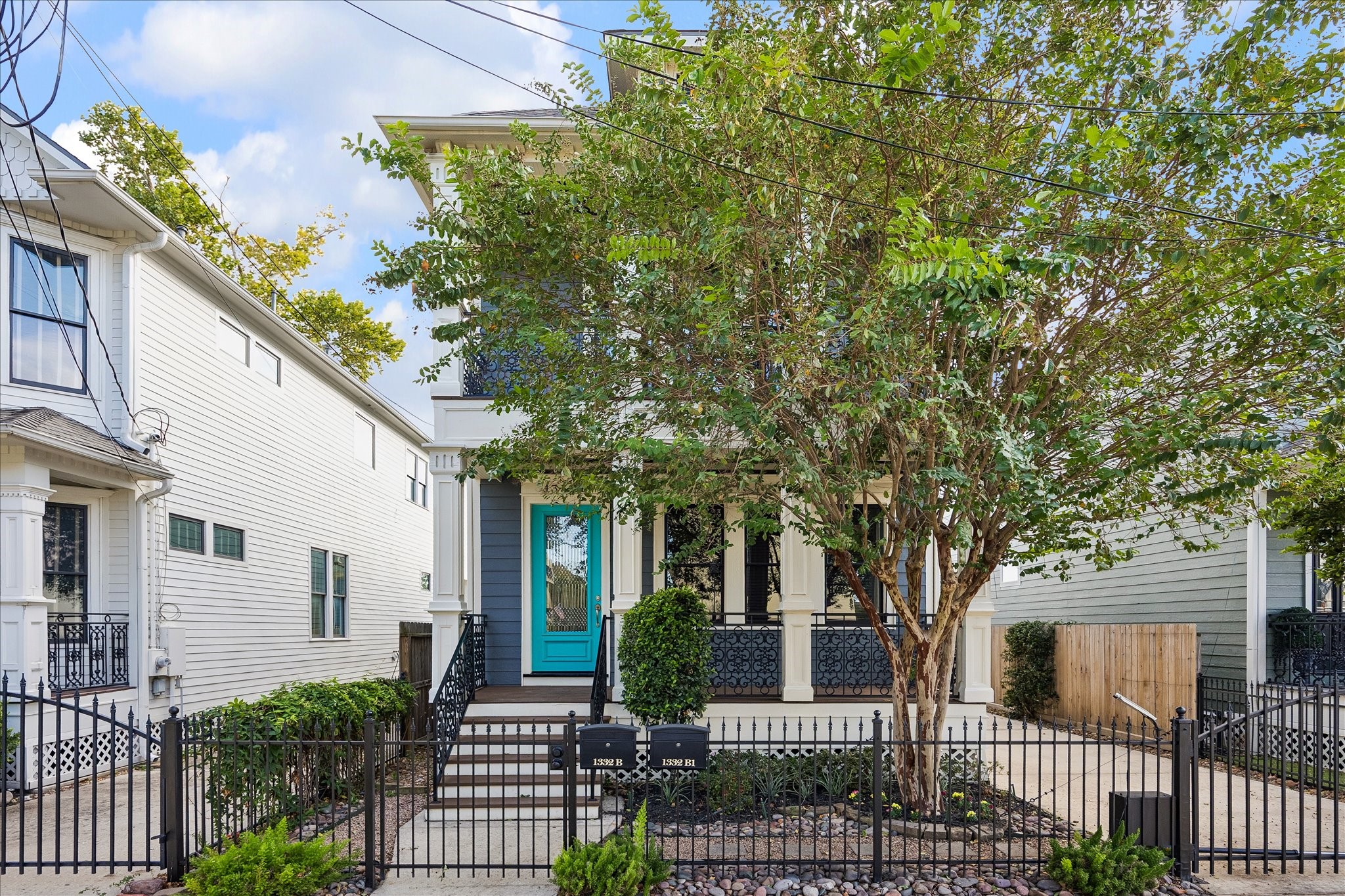New Orleans-inspired architecture, decorative ironwork, and a gated front courtyard create a distinctive first impression.
