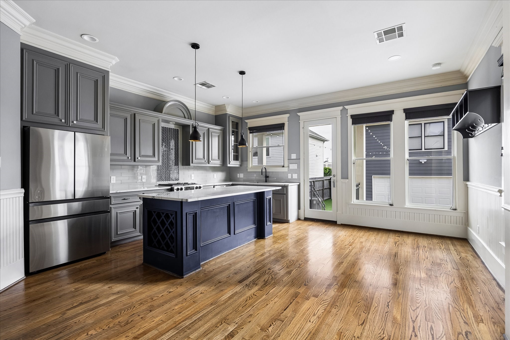 Generous windows and a glass exterior door fill the kitchen and adjoining breakfast area with natural light. Generous windows and a glass exterior door fill the kitchen and adjoining breakfast area with natural light.