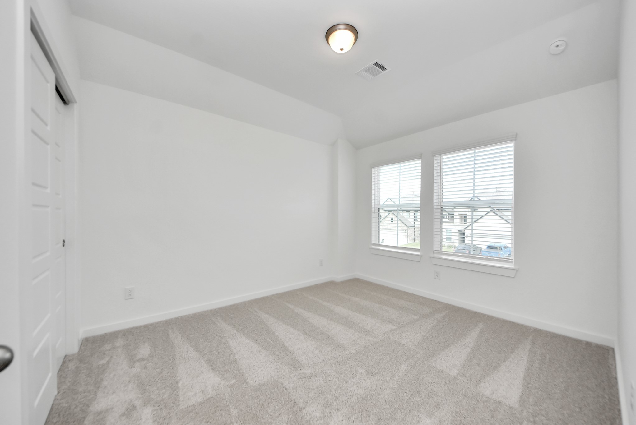 Generously sized secondary bedrooms featuring spacious closets, soft and inviting carpeting underfoot, large windows allowing plenty of natural light, and the added touch of privacy blinds for your personal retreat.