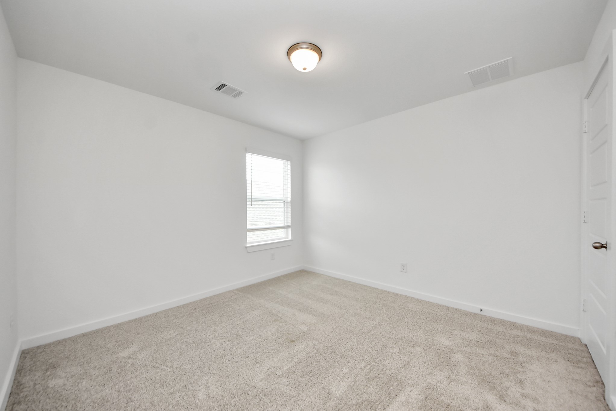 Secondary bedroom features plush carpeting, large windows that let in plenty of natural light, bright paint, and spacious closets.