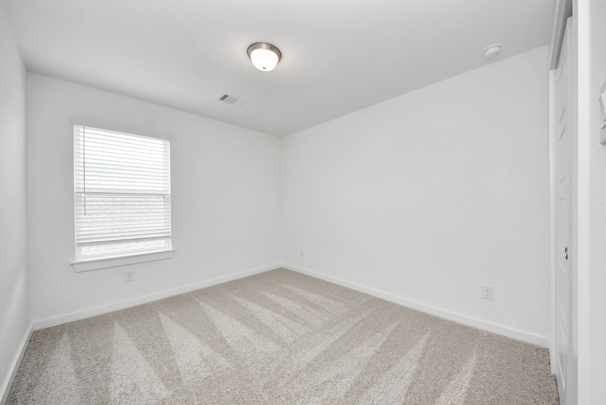 Generously sized secondary bedrooms featuring spacious closets, soft and inviting carpeting underfoot, large windows allowing plenty of natural light, and the added touch of privacy blinds for your personal retreat.