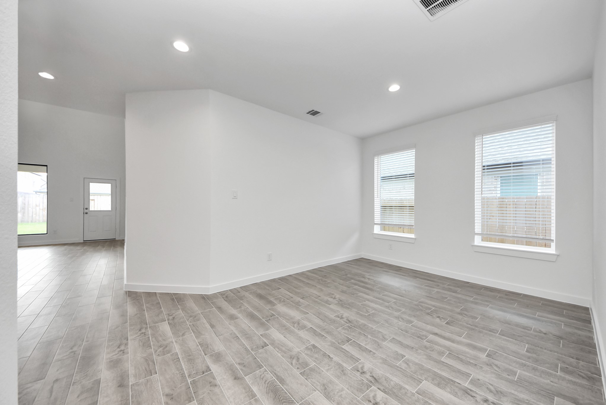 Create lasting memories with your family and friends at the dining table! This expansive dining room showcases sophisticated flooring, custom paint, and seamlessly connects to the family room and kitchen, providing an open and inviting atmosphere
