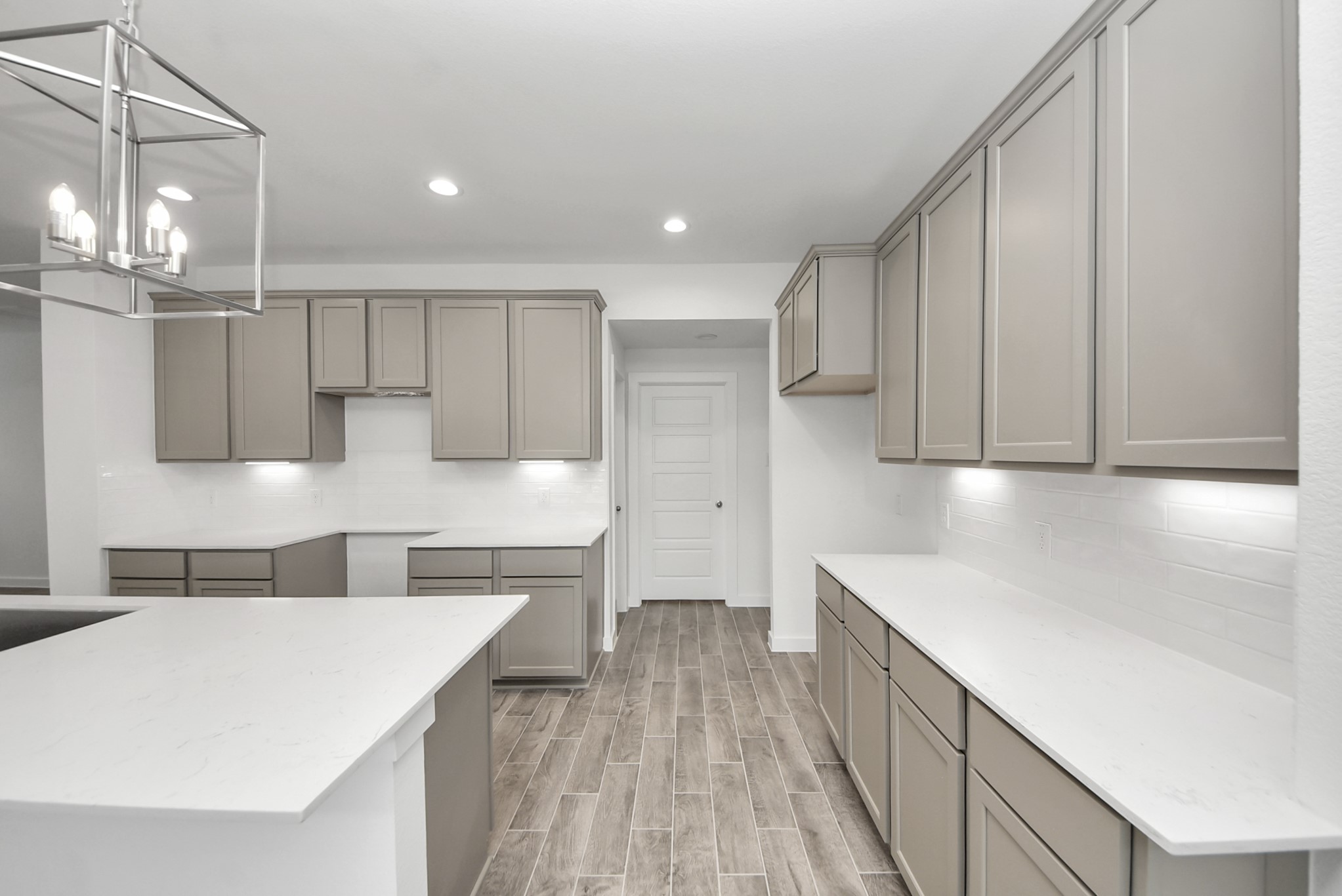 Step into a dream realized with this generously spacious kitchen! A massive granite island takes center stage, complemented by high ceilings and soft-close cabinets. The granite countertops, stainless steel appliances, sleek tile backsplash, and recessed lighting complete the elegant design.