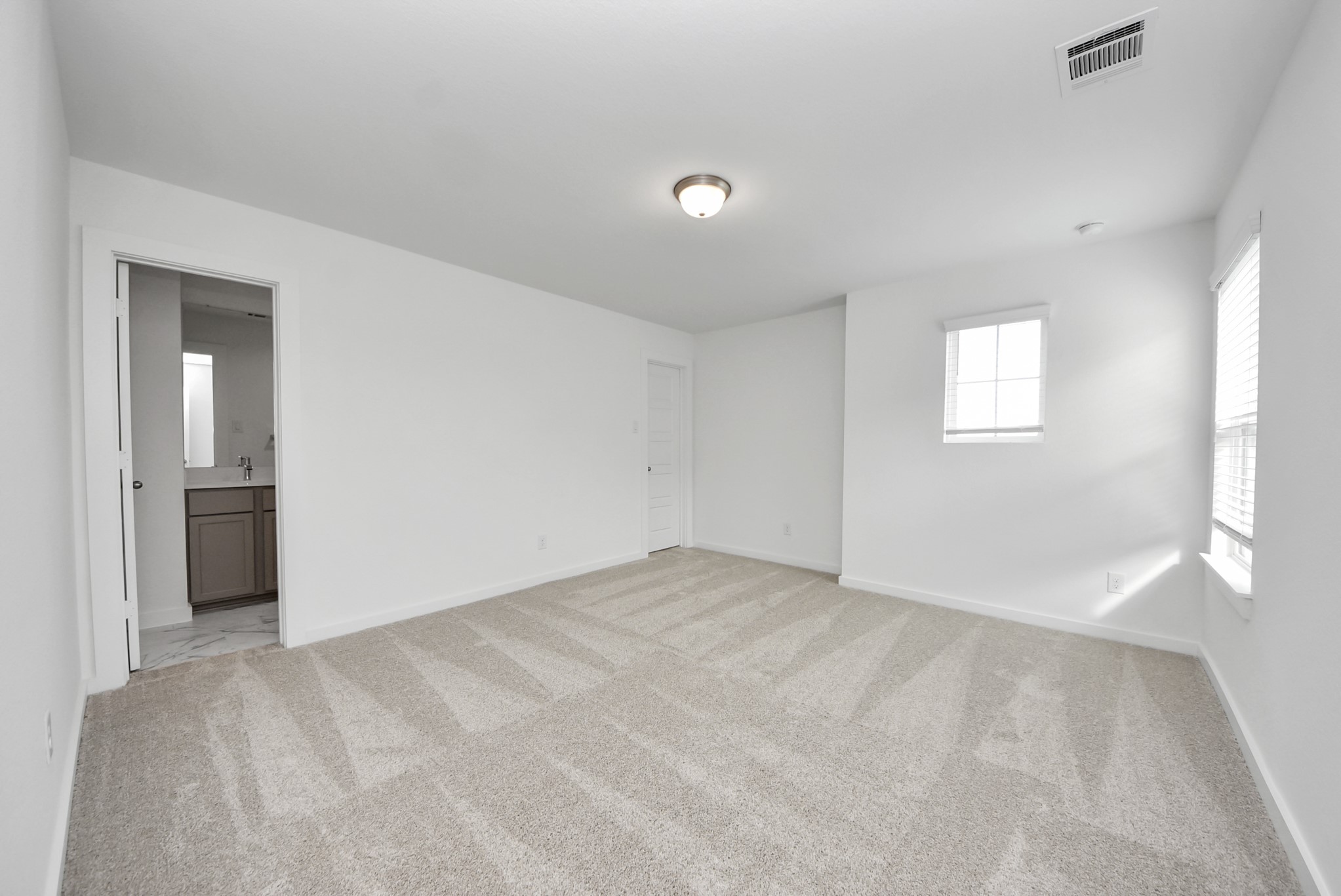 Generously sized secondary bedrooms featuring spacious closets, soft and inviting carpeting underfoot, large windows allowing plenty of natural light, and the added touch of privacy blinds for your personal retreat.
