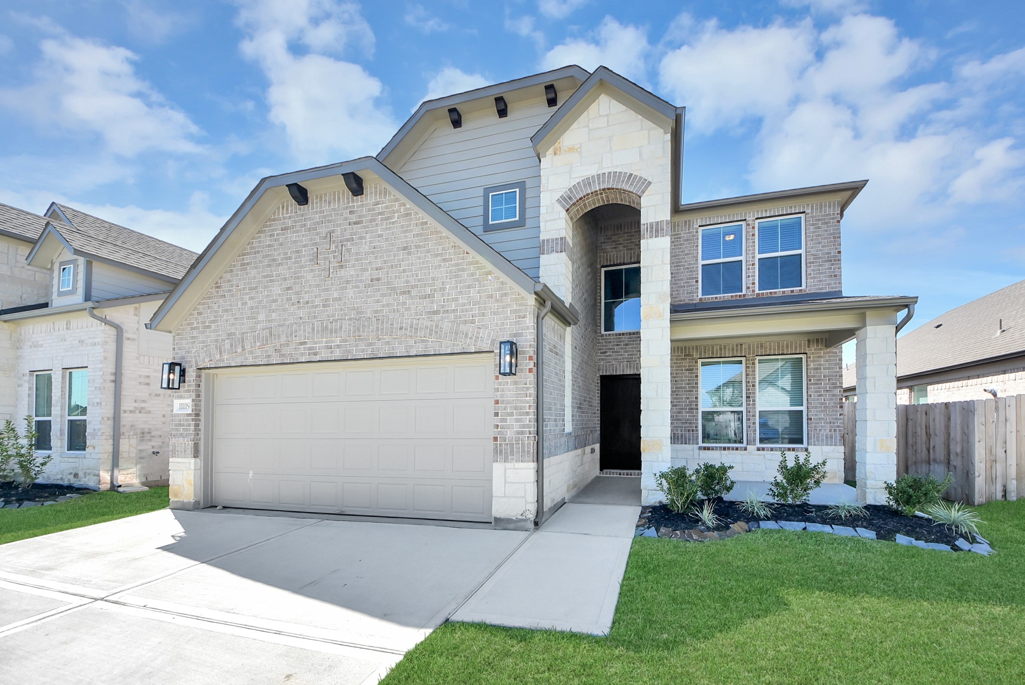 The residence features a practical 2-car garage complemented by a generous driveway, ensuring abundant space for parking needs.