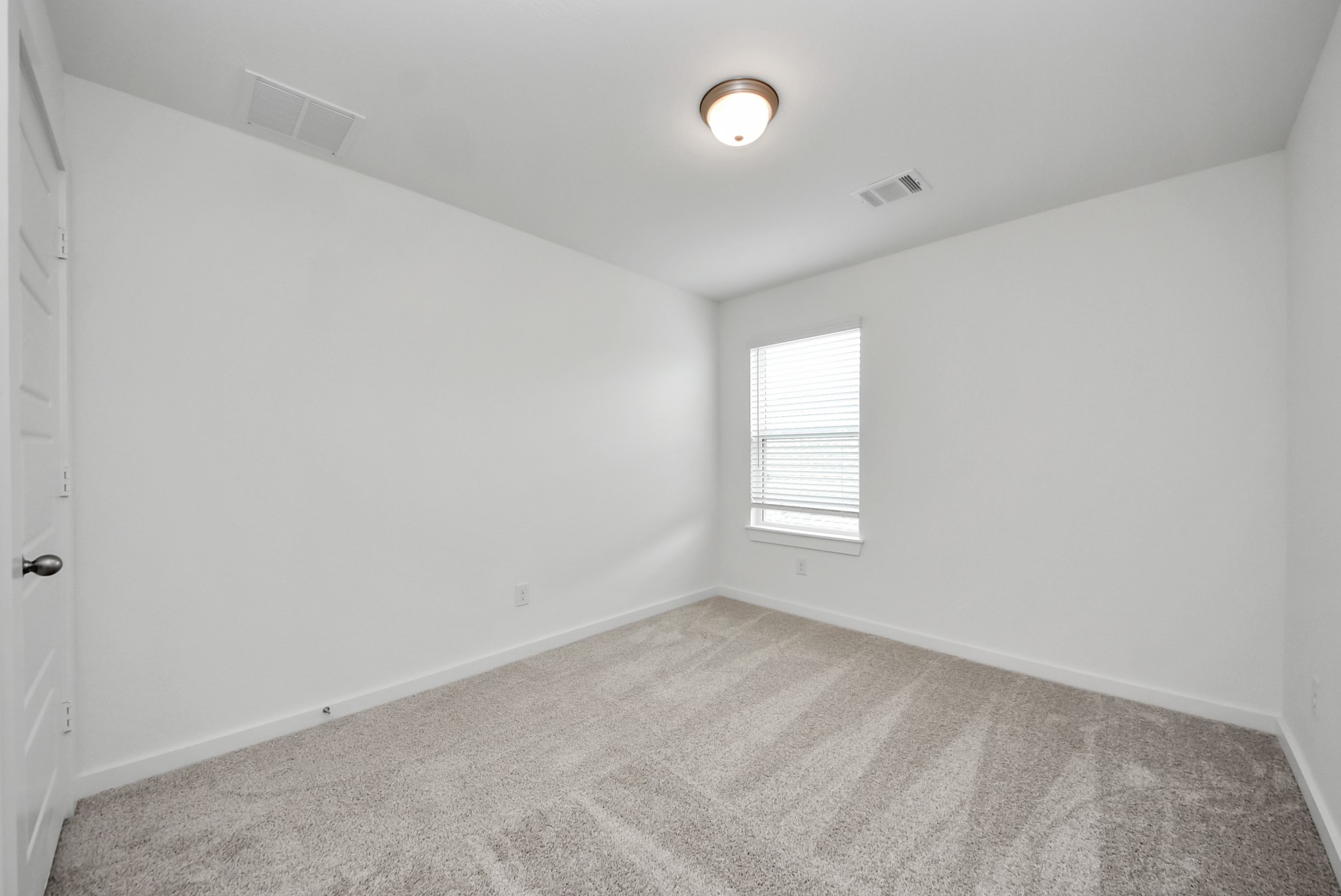 Secondary bedroom features plush carpeting, large windows that let in plenty of natural light, bright paint, and spacious closets.