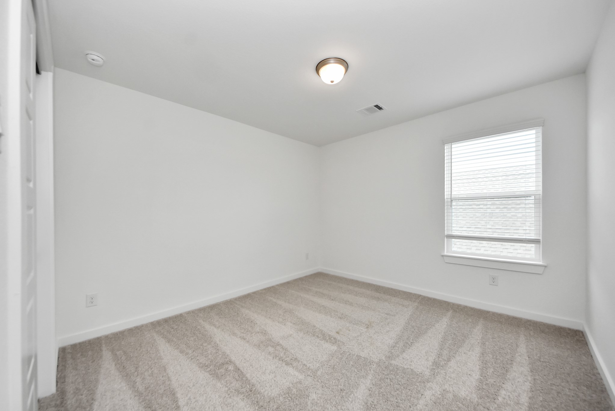 Generously sized secondary bedrooms featuring spacious closets, soft and inviting carpeting underfoot, large windows allowing plenty of natural light, and the added touch of privacy blinds for your personal retreat.