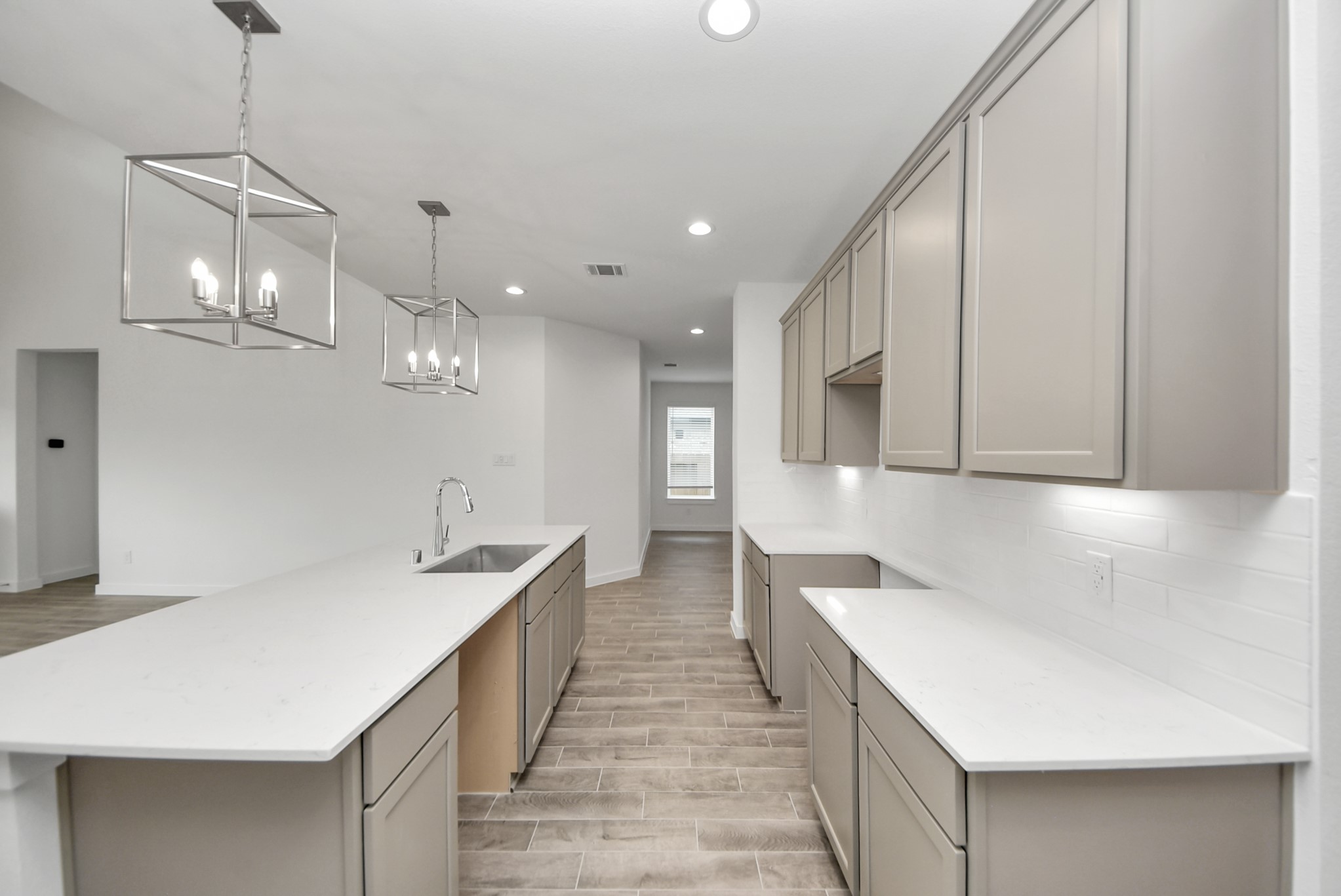 The open concept effortlessly connects the kitchen to the expansive family room, forming a perfect hub for gatherings. This seamless flow creates an inviting space where cooking and socializing come together harmoniously.