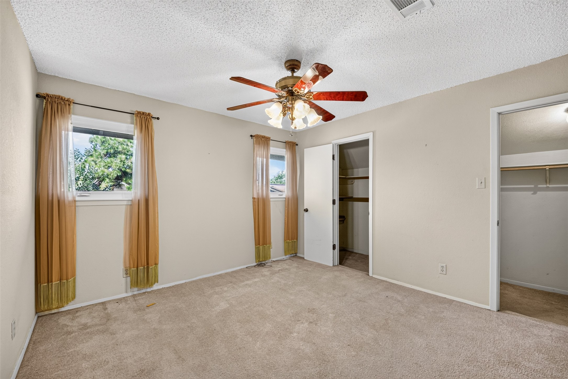 Secondary bedroom facing the backyard with multiple deep closets