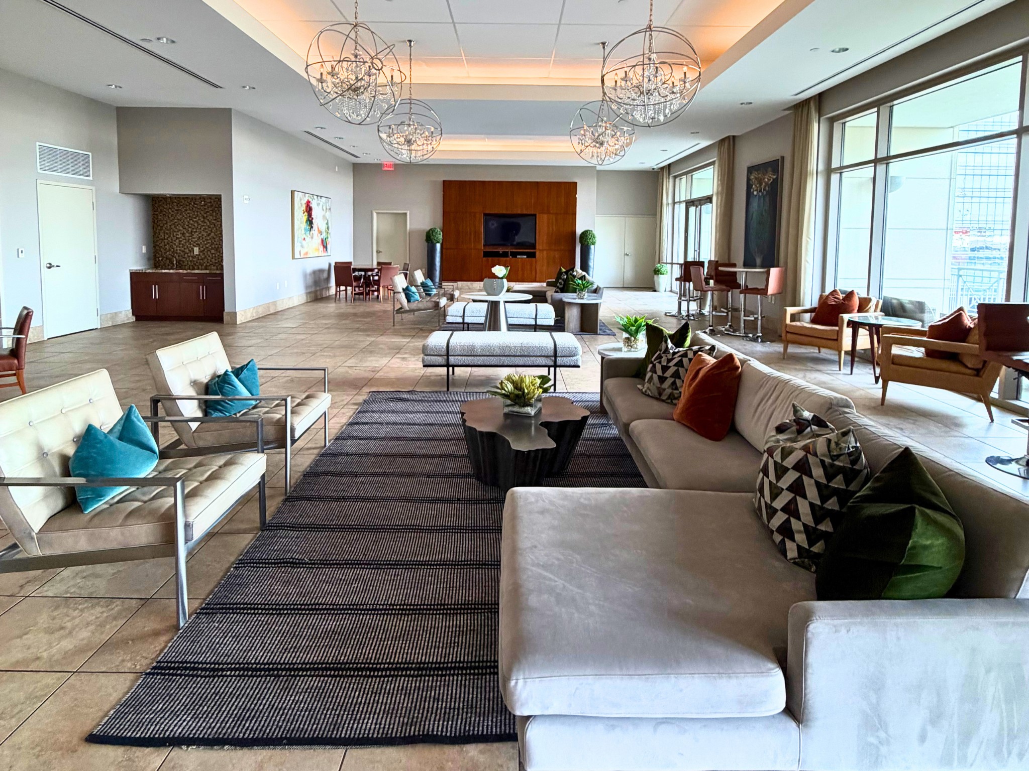 The expansive resident lounge offers an elegant space to relax, socialize, or entertain. Thoughtfully designed with multiple seating areas, sophisticated finishes and seamless access to the outdoor terrace, this inviting gathering space is ideal for everything from casual conversations to private events.