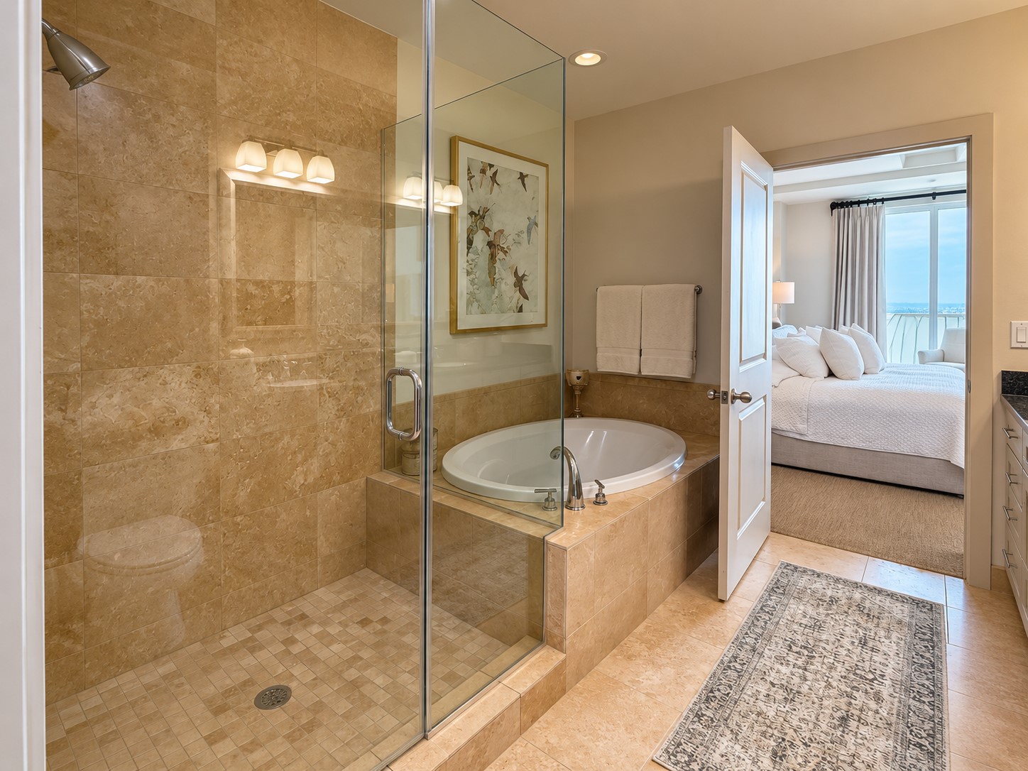 A true retreat within the residence, the primary bath pairs a glass-enclosed shower with a deep soaking tub for a spa-like experience at home. Its the kind of space that makes slowing down at the end of the day feel effortless.